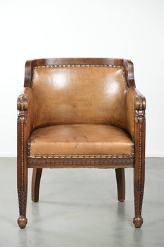 Antique armchair made of sheepskin and wood with decorative nails