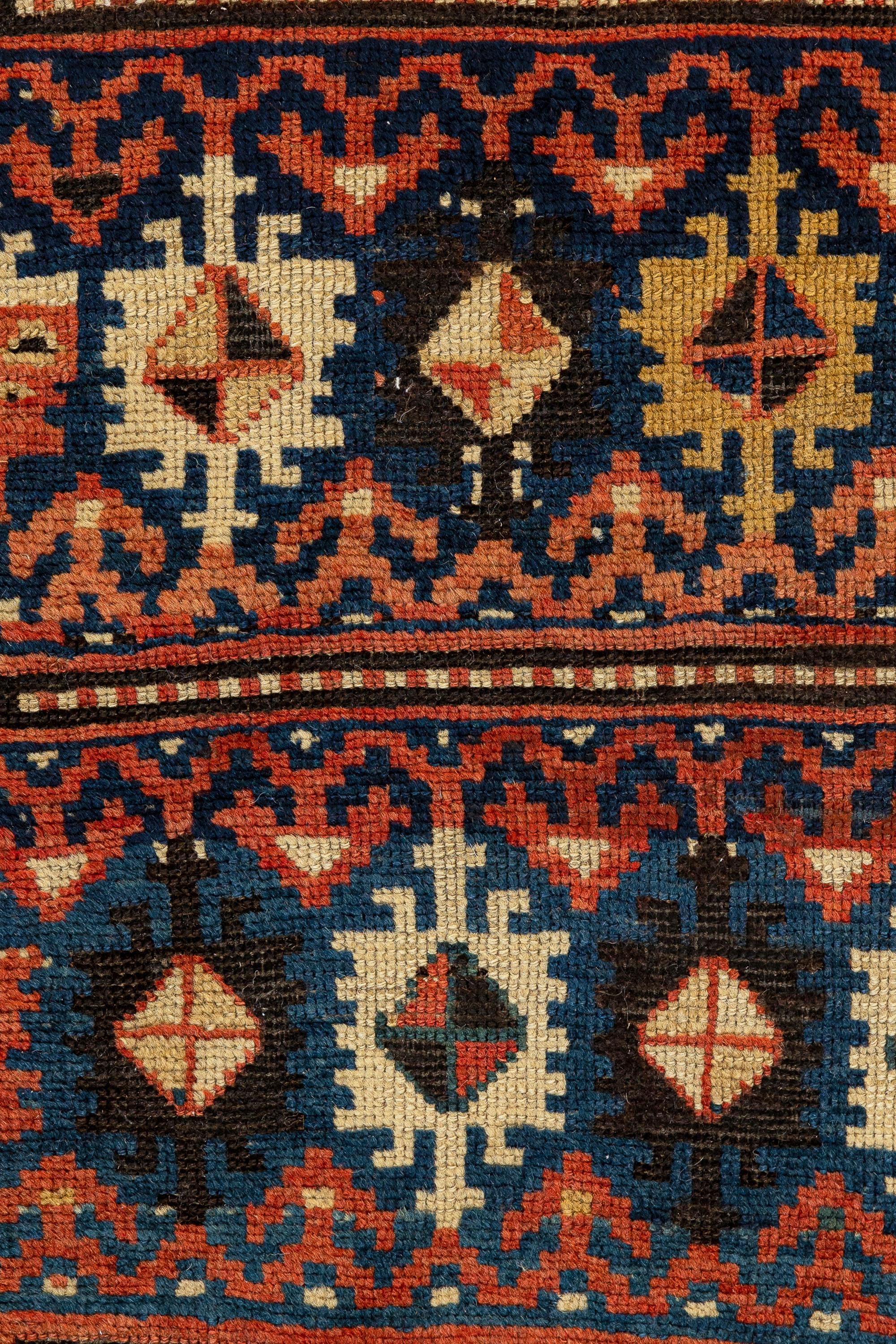 Armenian Kazak - Central Caucasus
This is a unique rug, different from the classic Caucasian ones. It contains seven rows with colourful geometric figures formed by serrated squares with diamonds in their centre. Rows of red arrows support these