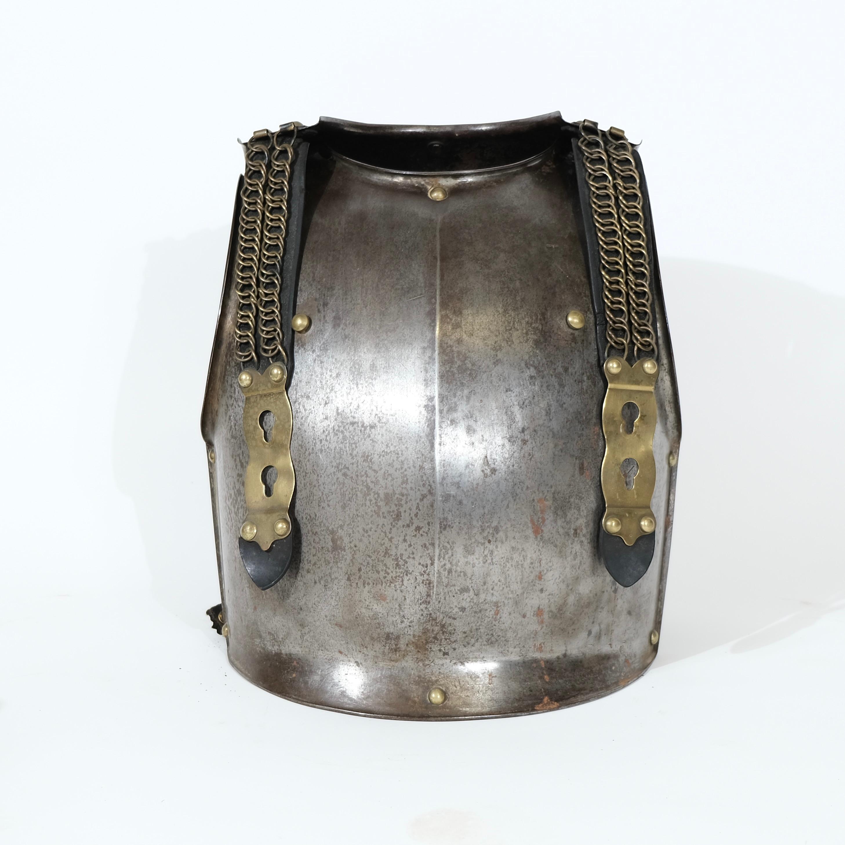 This iron cuirass ( front and back piece), which is a type of body armor that covers the torso, is used by soldiers for protection in combat. This cuirass has a robust design, indicative of the practical military equipment of the early 19th