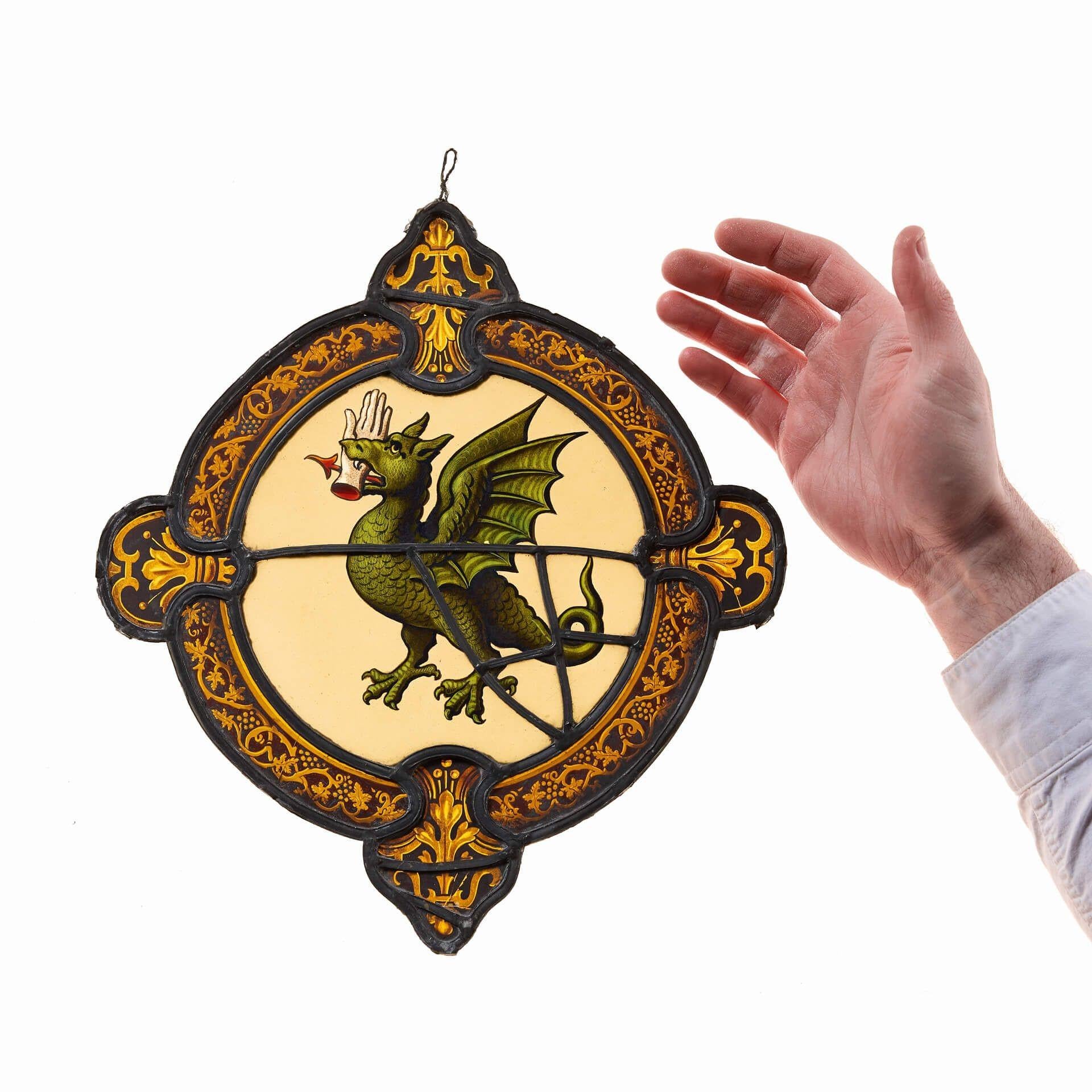 An armorial stained glass panel depicting the vivid scene of a beastly dragon.

Dating to circa 1850, this antique stained glass window features a vibrant array of coloured glass panes, to be brought to life by natural light.

The design centres