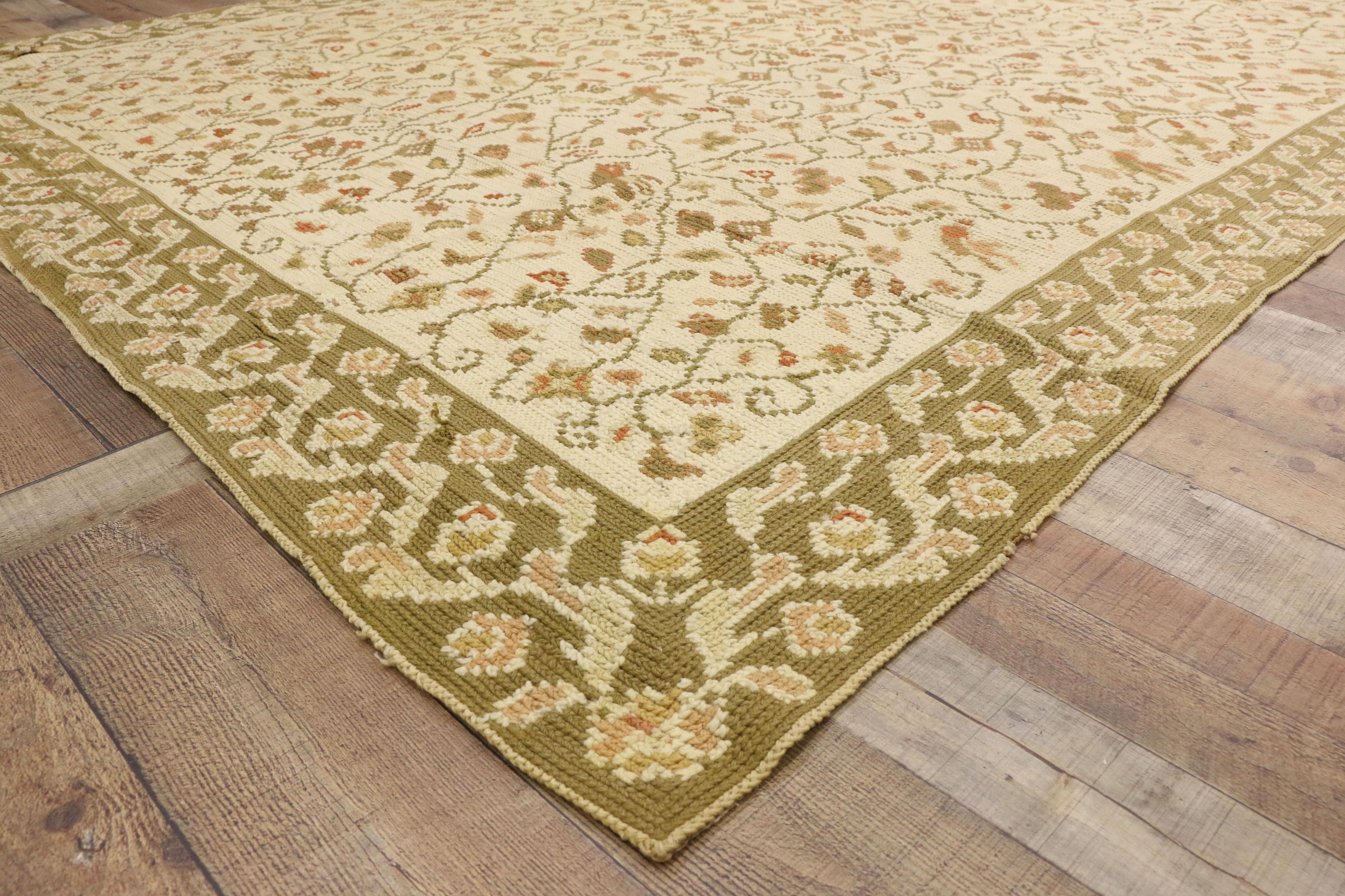 77210, antique Arraiolos rug with European Country Charm, Portuguese needlepoint rug. This daintily needlepoint antique Arraiolos rug features an all-over pattern of tiny florals amidst a flurry of leafy tendrils. The tendrils form a rapturing