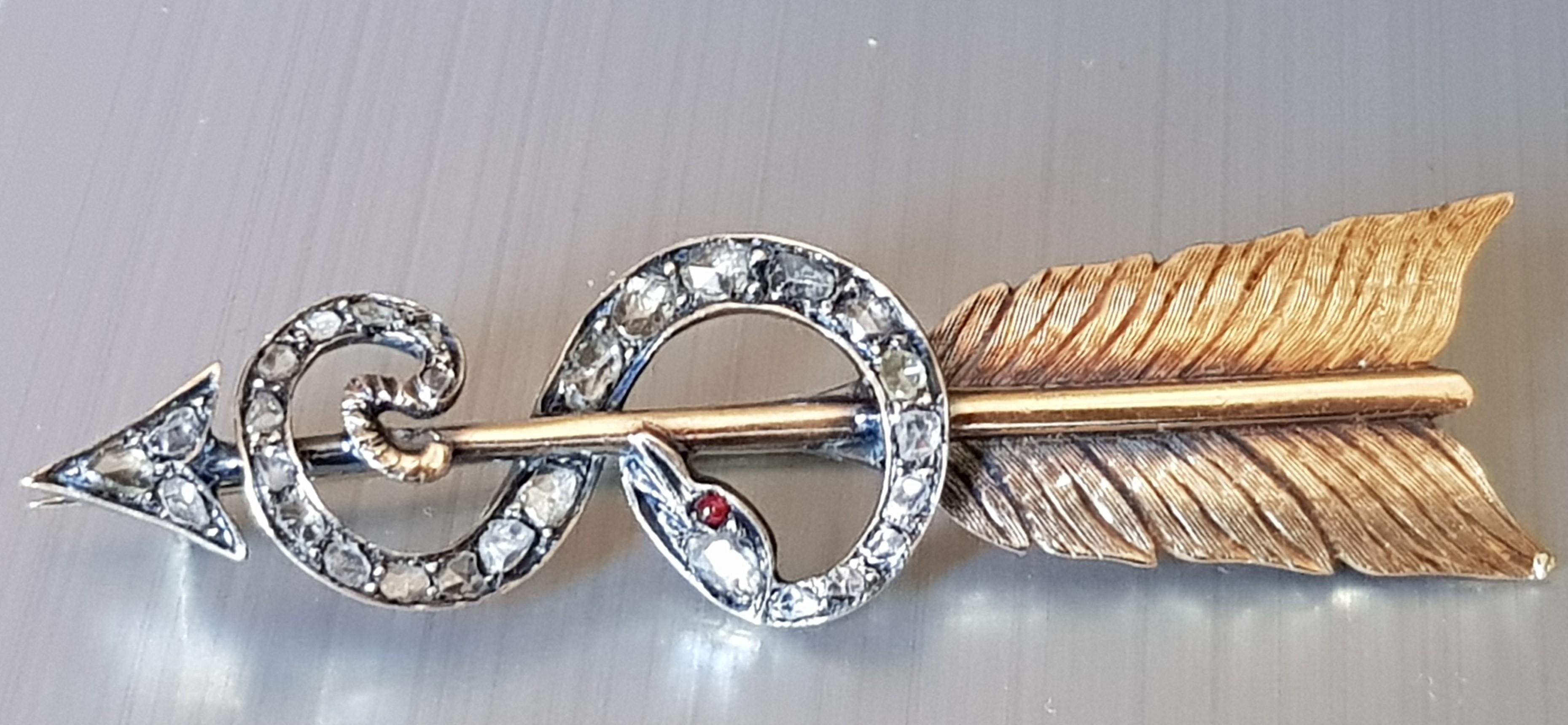 Antique Arrow and Snake Rose Cut  Diamond Silver and Gold Brooch (France) 19th Century
A spectacular, and  large Victorian brooch depicting a ruby-eyed snake wound around an arrow. Studded with rose cut diamonds in silver over gold 18 Karat. This
