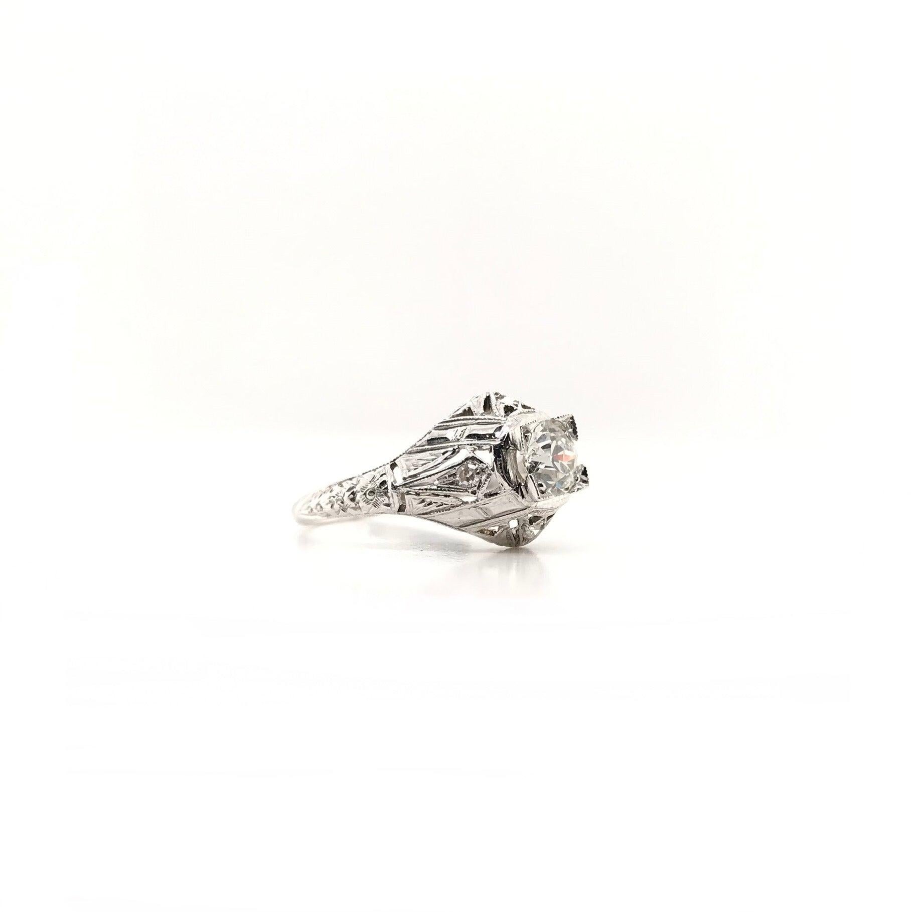 This stunning antique piece was skillfully handcrafted sometime during the Art Deco design period (1920-1940). The platinum setting is absolutely exemplary of it’s design period; featuring a complex structural motif, clever filigree, clean lines,