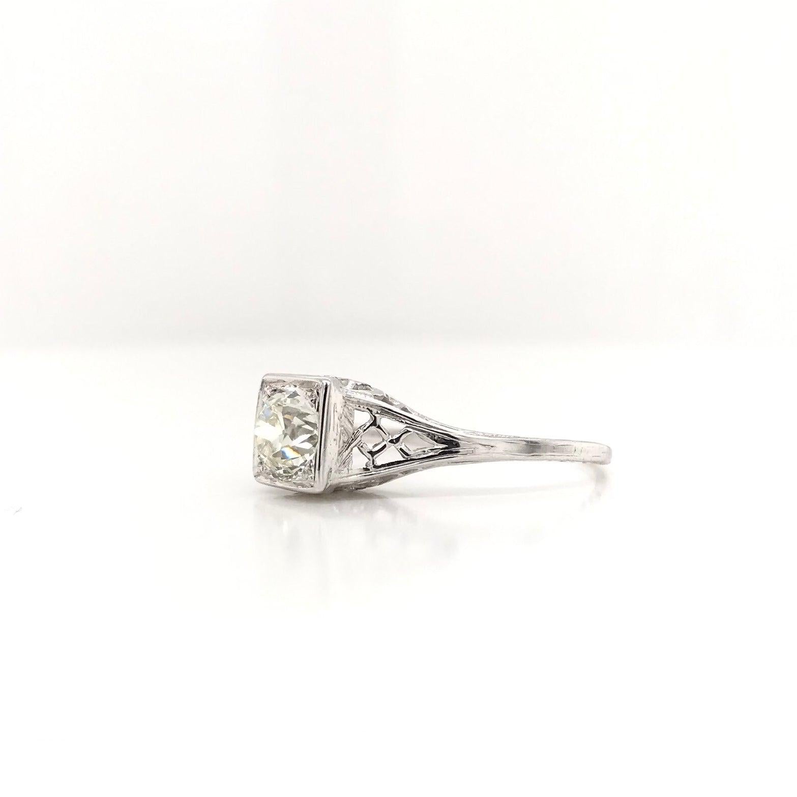 This beautiful antique piece was skillfully handcrafted sometime during the Art Deco design period (1920-1940). The 18K white gold filigree setting features one central diamond. The diamond is an antique Old European cut and measures approximately