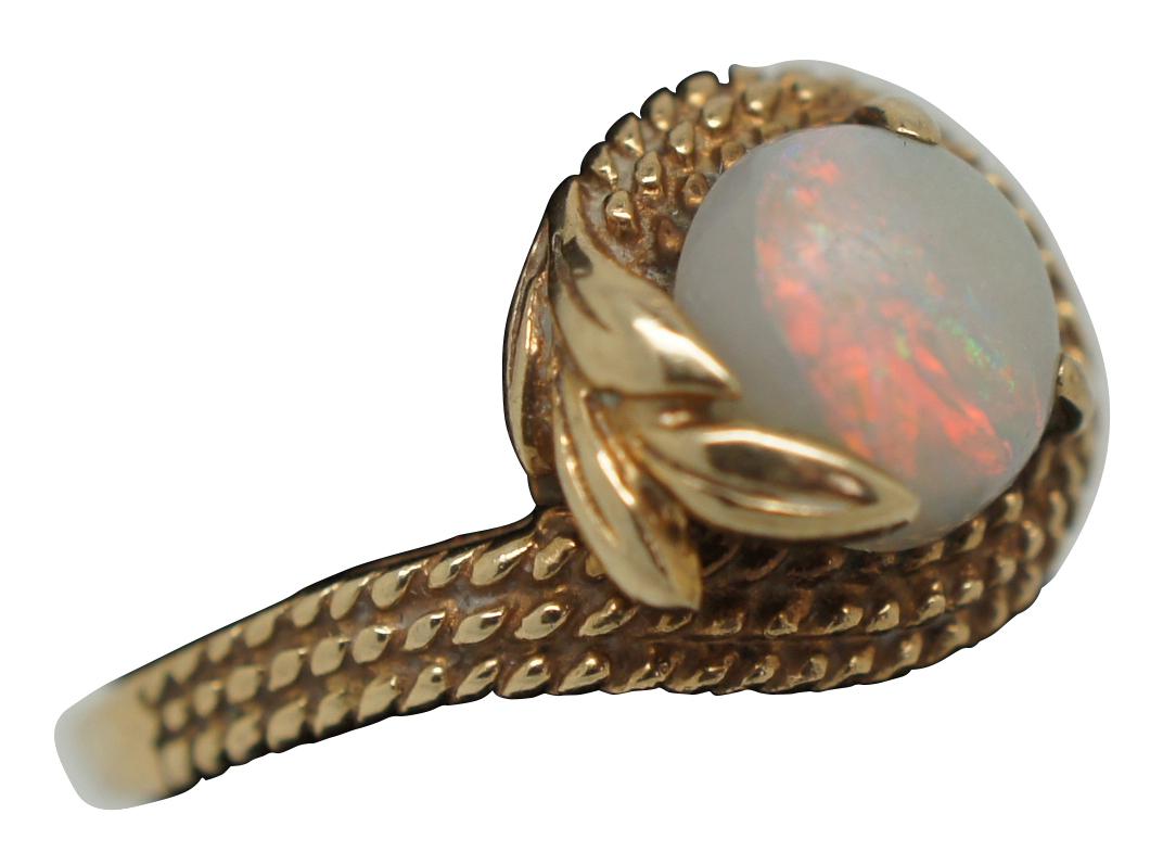 Antique 10K yellow gold ring with rope twist setting ending in curling leaves around a white cabochon opal.

Size 6.5 / setting - 0.5” x 0.375” / 3.5 g (width x depth / weight).

