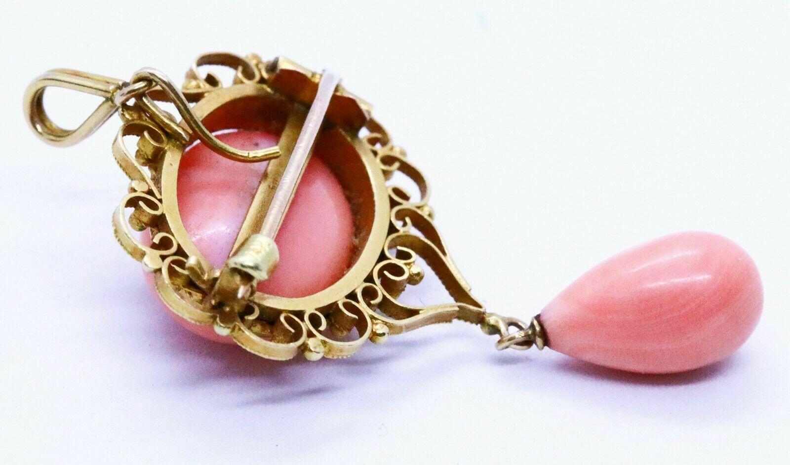 This gorgeous rare Italian antique salmon coral pendant brooch was handmade in Italy circa 1900's.  It is crafted in 14k yellow gold with the filigree technique.  The piece is set with a pin steam steam bar on the reverse and also with 
an invisible