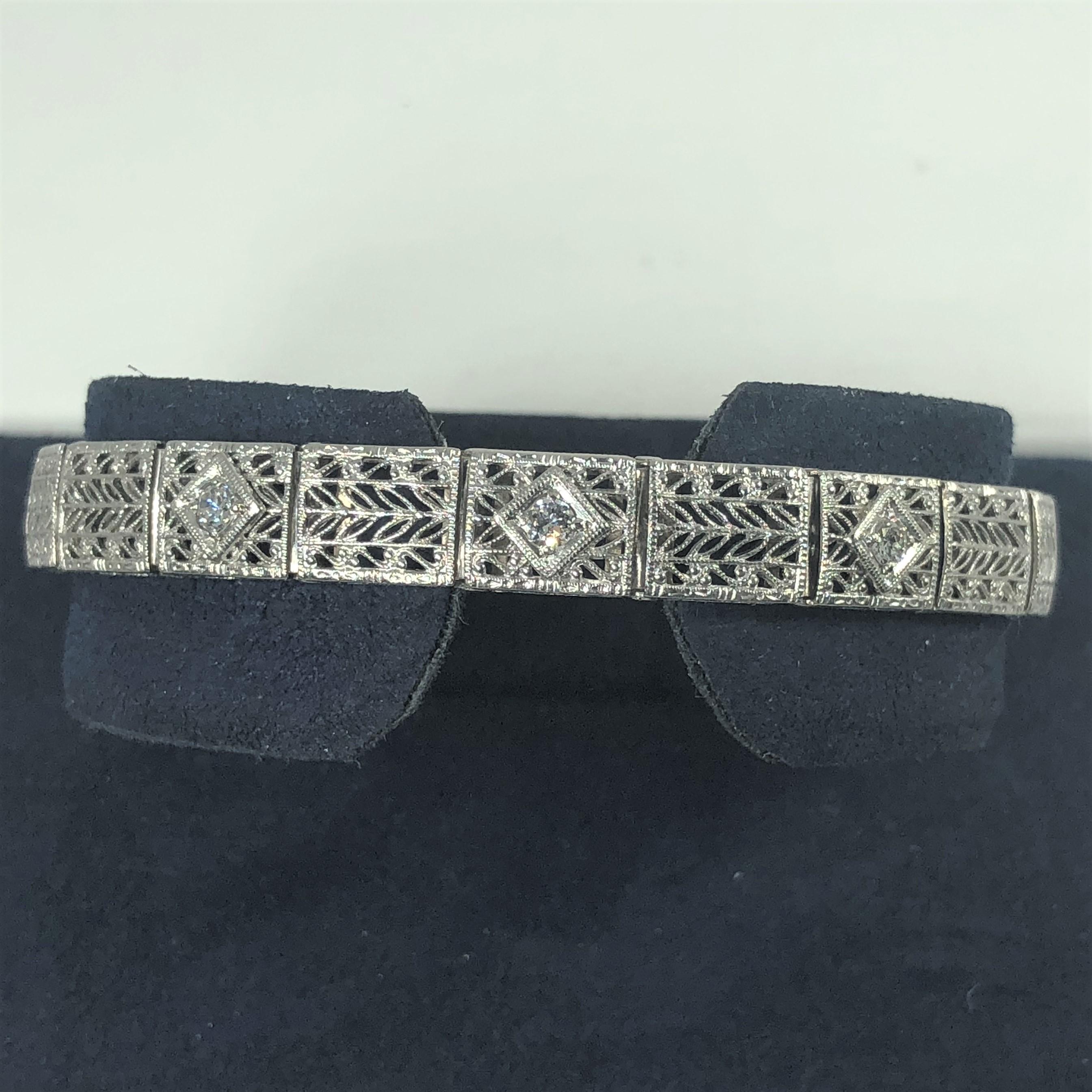 Antique Art Deco 14 Karat white gold Diamond 3 Stone filigree bracelet. This true Art Deco Antique is an exquisite one of a kind bracelet. Created in 14 karat white gold weighing 13.6 grams. Adorned with 3 round cut diamonds, 0.35 total weight.