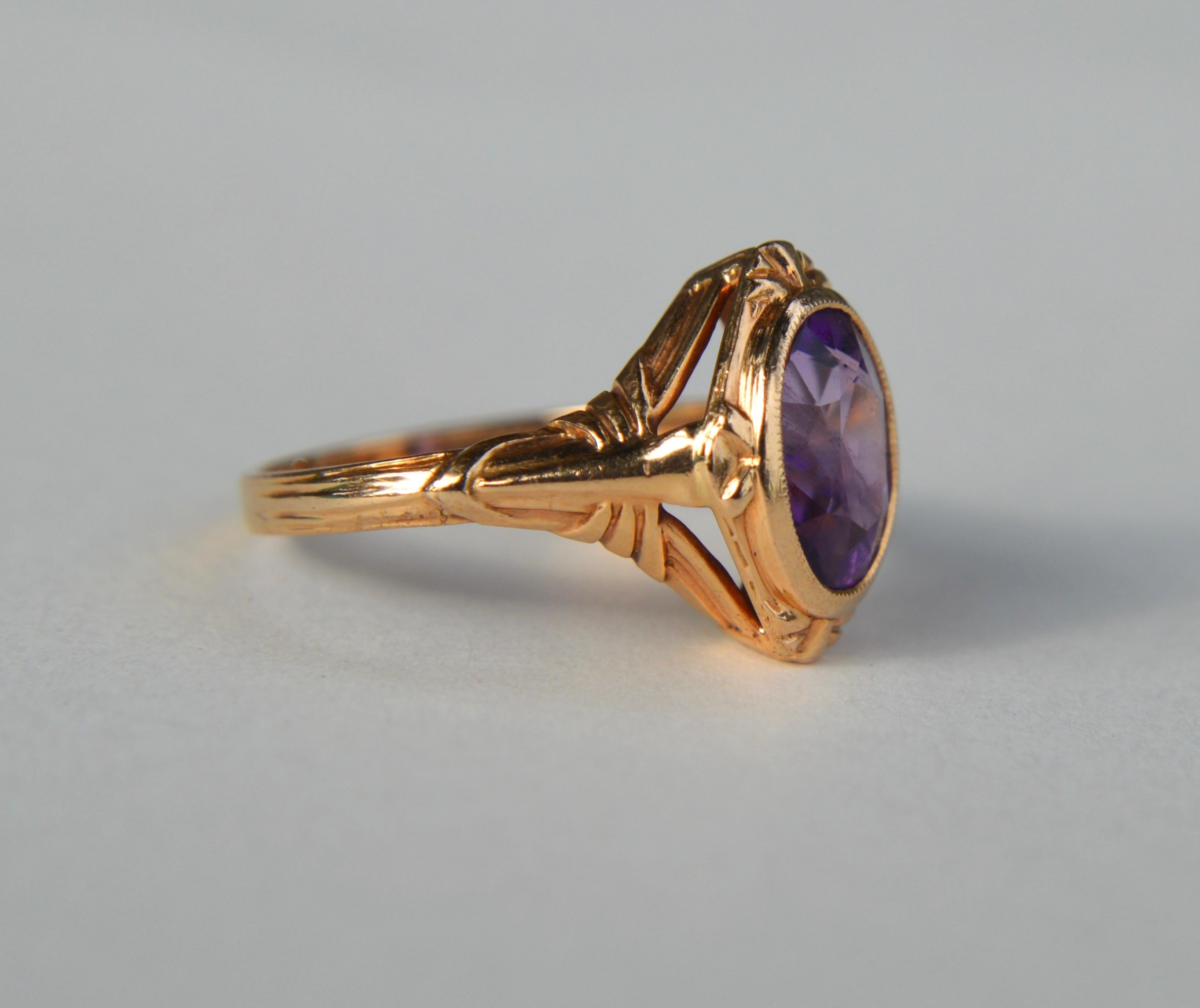 Beautiful Art Deco era antique circa 1920s 14K rose gold 1.41 carat oval cut natural amethyst ring (9x7mm). In very good condition. The amethyst has internal diagonal striation inclusions that are not structural damage or cracks. It is nonetheless