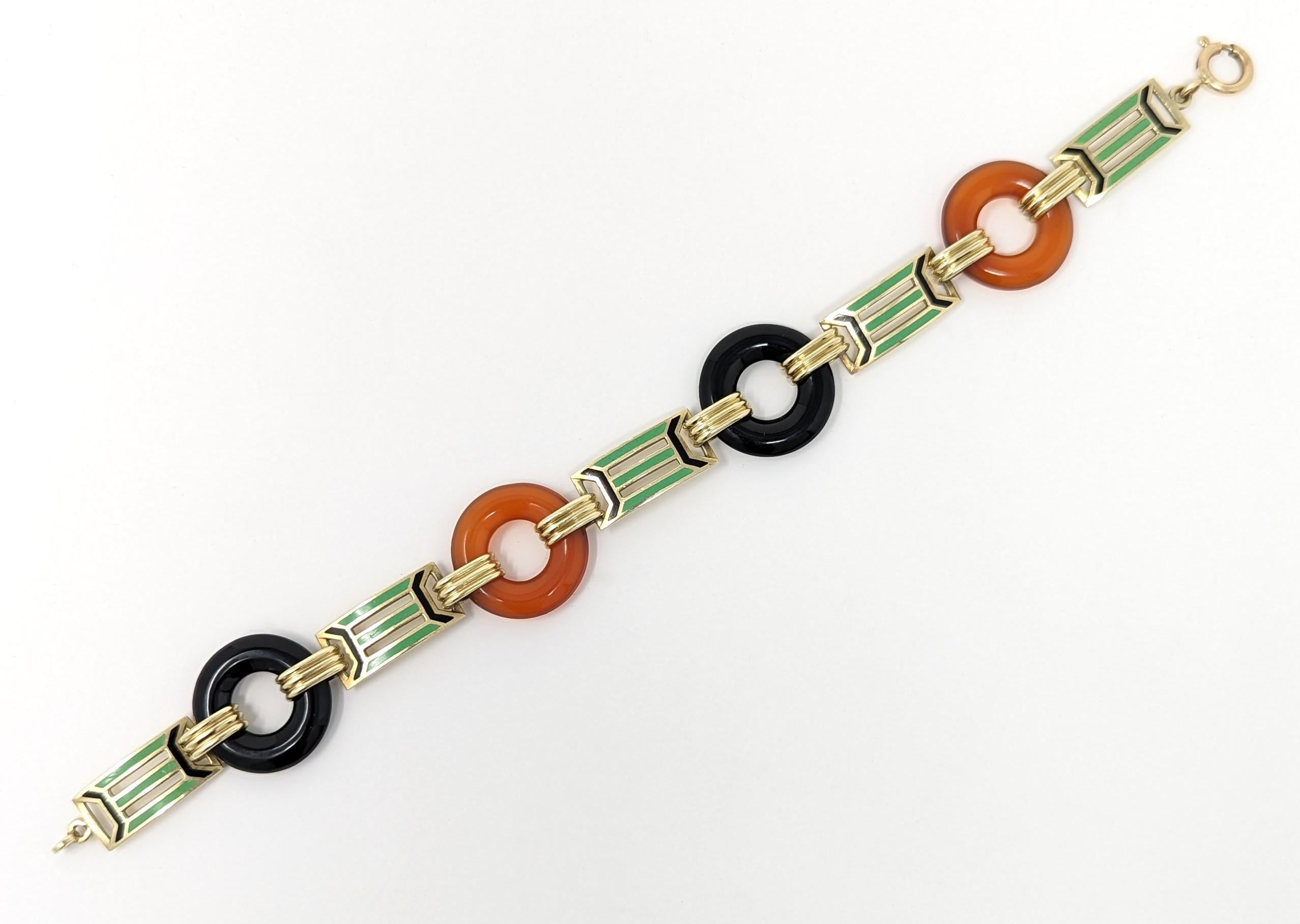 Absolutely stunning antique art deco bracelet created in solid 14k yellow gold. Featuring luscious enamel with alternating carved carnelian and onyx stone links. Hallmarked / stamped on the clasp and the last panel. Measures 7.5 inches from one end