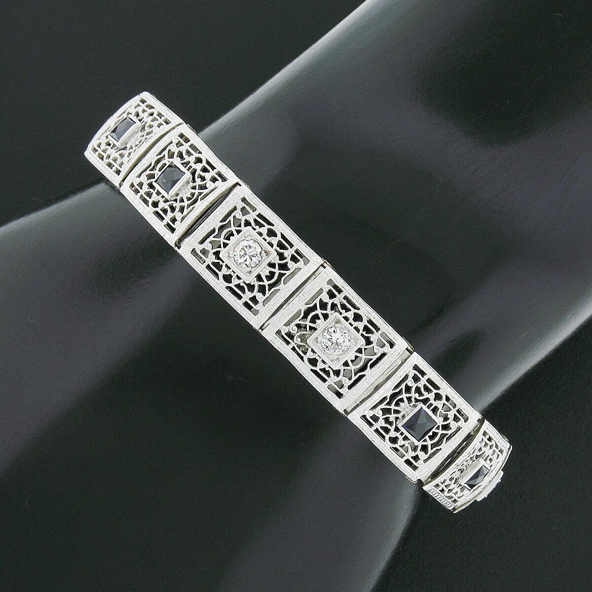 Here we have an absolutely incredible antique bracelet that was crafted in solid 14k white gold during the are deco period. It features wide rectangular links that are fully and elegantly decorated with truly outstanding open filigree and engraved