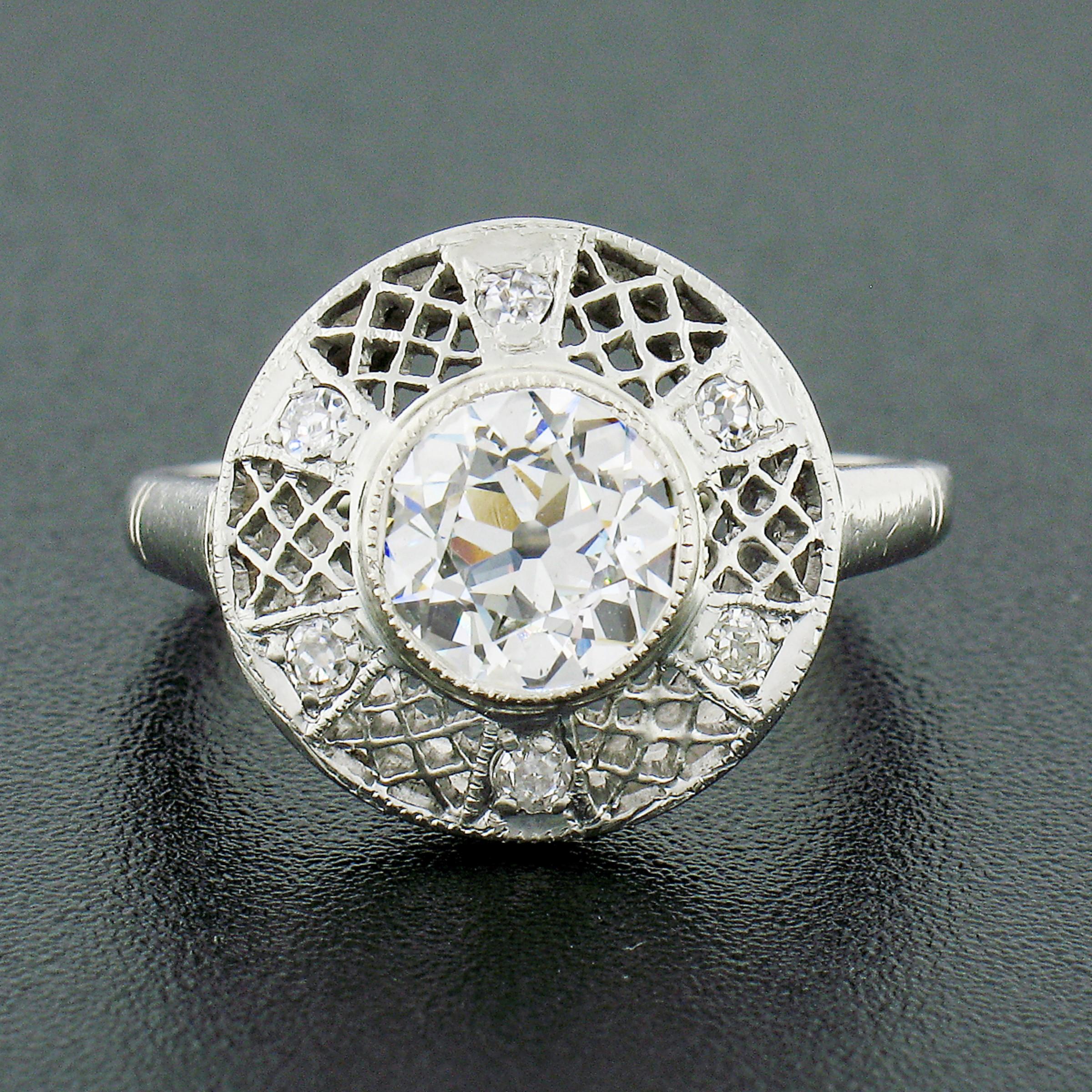 This beautiful antique diamond engagement ring was crafted from solid 14k white gold during the art deco period and features a, GIA certified, old European cut diamond solitaire neatly milgrain set at its center. The diamond is exactly 1.31 carats