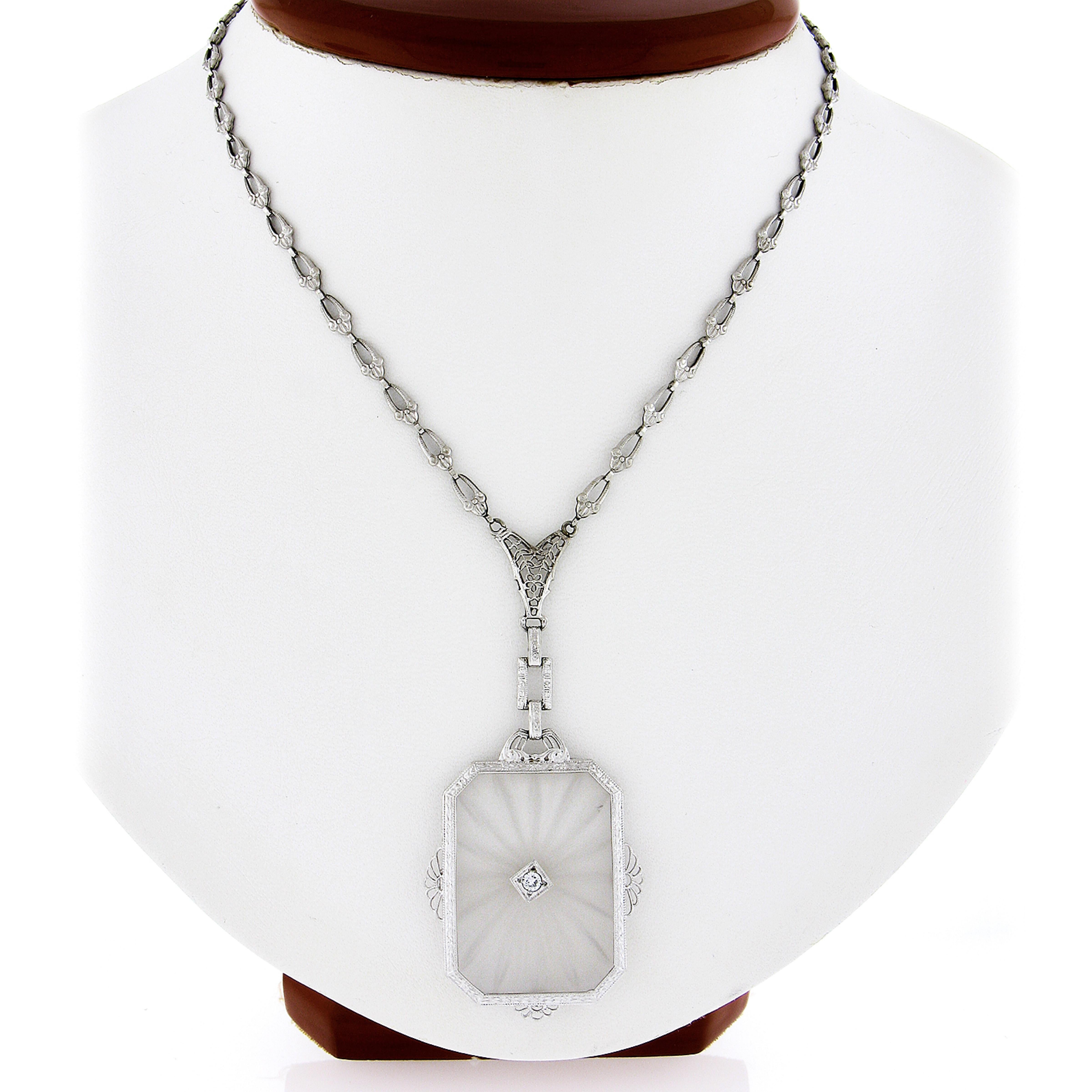 This is a gorgeous and rare necklace crafted during the art deco period in solid 14k white gold. It features a large, rectangular-shaped, carved camphor glass with the frame and links that attach to the chain having magnificent etching designs and