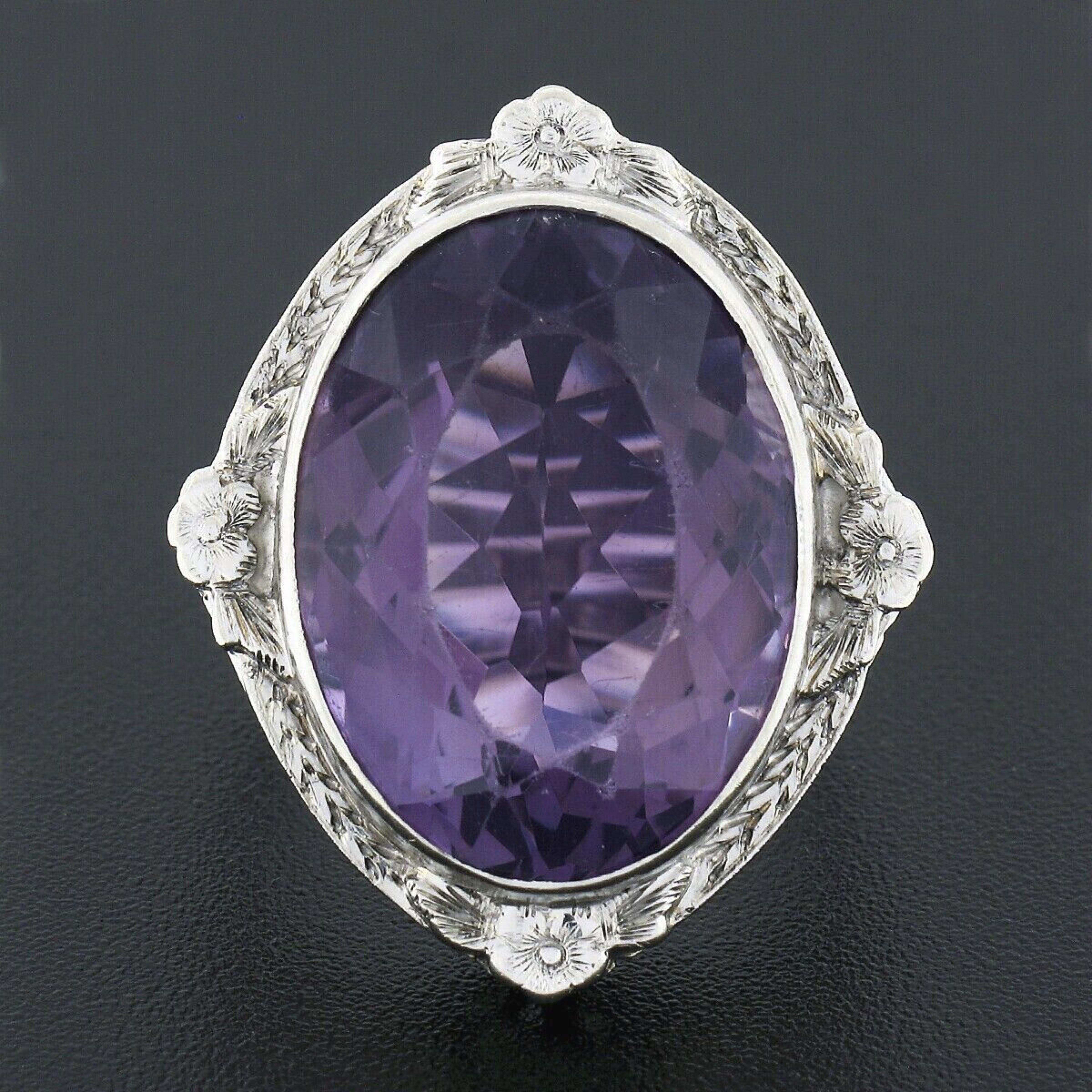 This magnificent antique cocktail ring was crafted from solid 14k white during the art deco period. The ring features a large, approximately 20x14.5mm, natural amethyst stone neatly bezel set at its center showing transparent medium purple color.