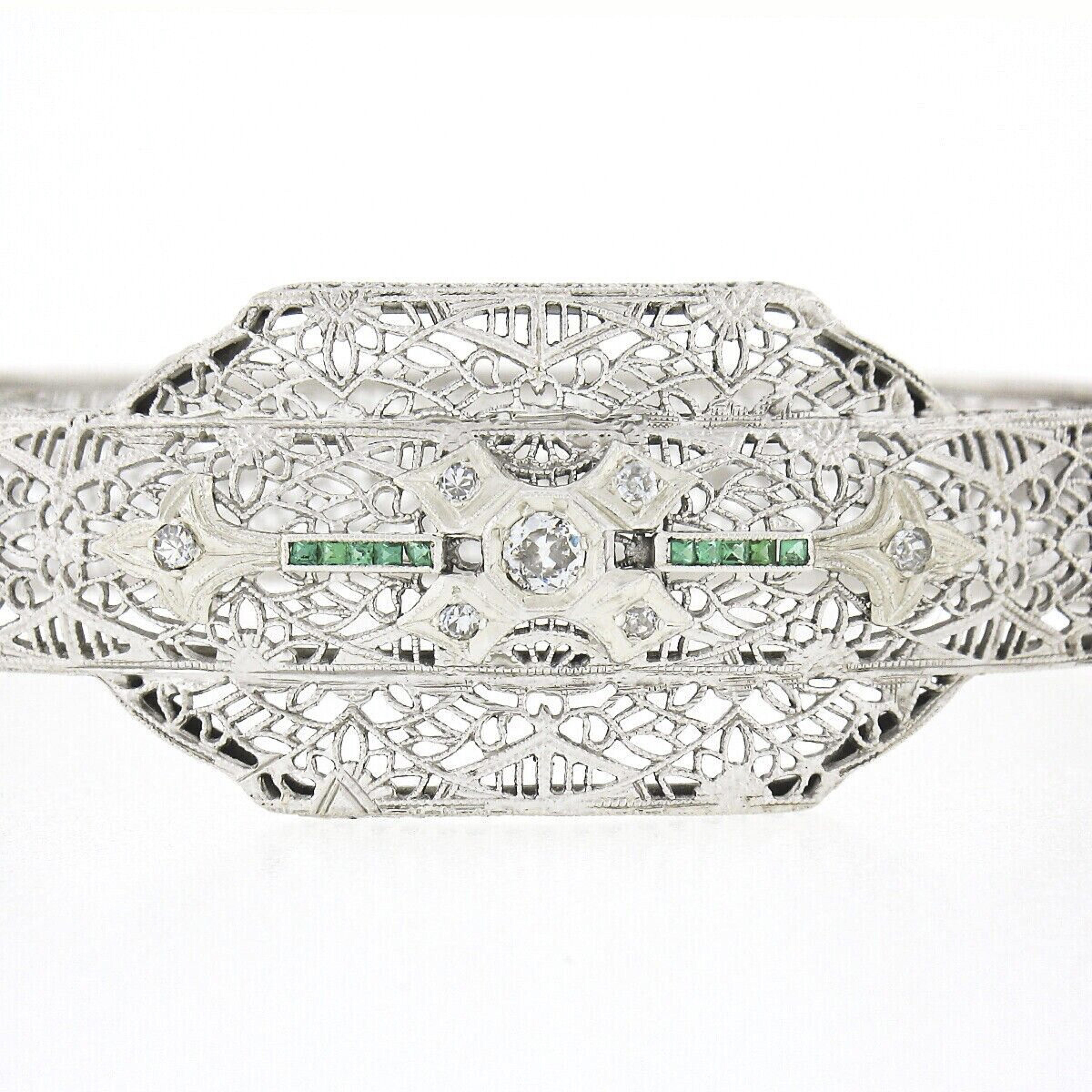 Here we have a magnificent antique bangle bracelet crafted from solid 14k white gold with a platinum top during the art deco period. This rare bangle style bracelet is completely covered with outstanding open filigree work and etched floral designs