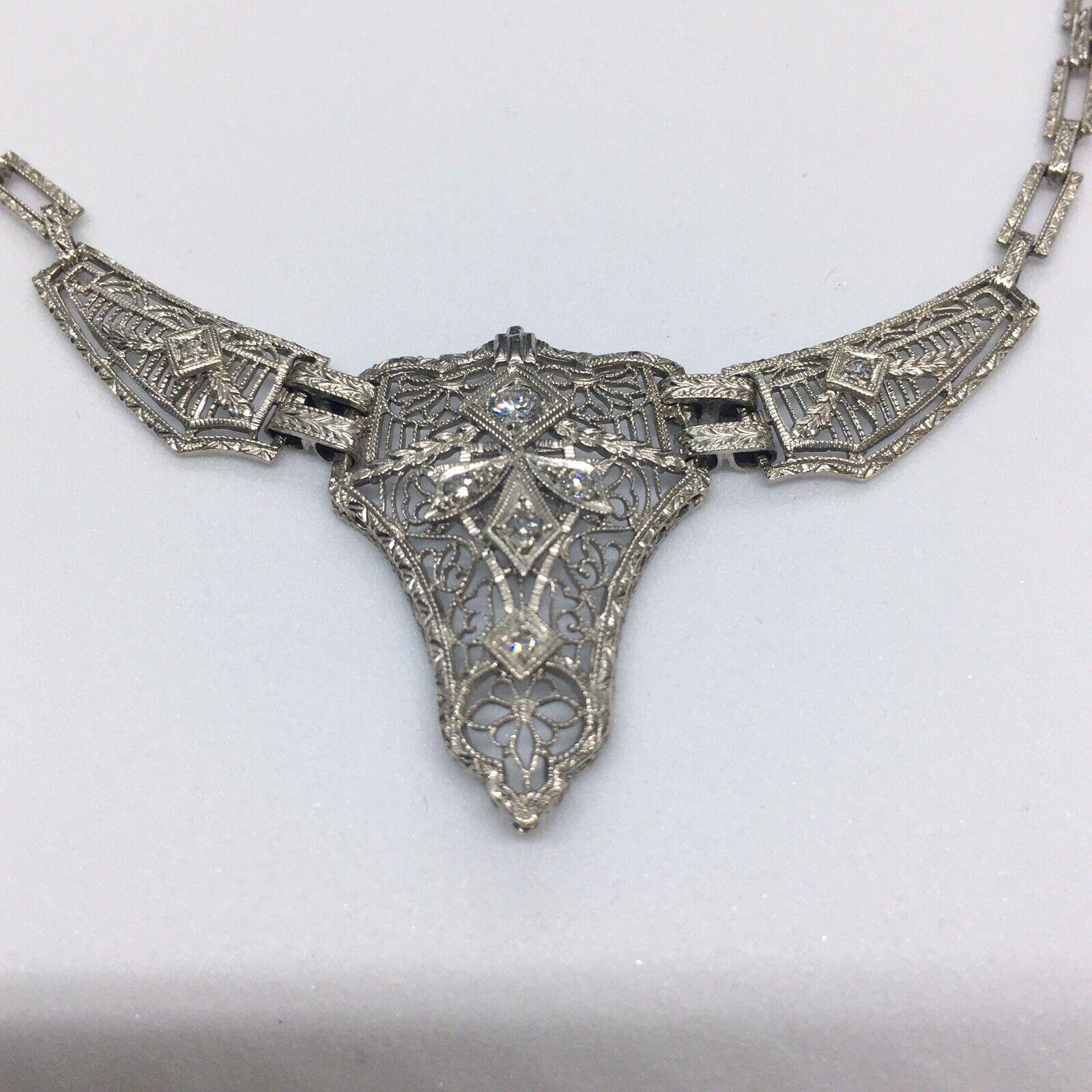 Platinum Topped Gold Necklace 

Antique Art Deco 14K Gold & Platinum American Made Necklace Hallmark 1920s

Weighting 10.4 gram
16 inch long
Center piece 1.25 inch long
Total of 0.20 carat Diamonds 7 Single Cut and one larger Transition Cut
Links
