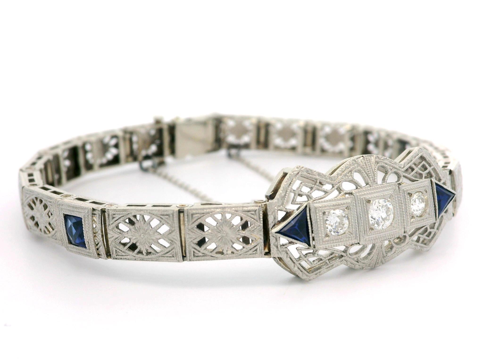 --Stone(s):--
(3) Natural Genuine Diamonds - Old European Cut - Pave Set - H/I Color - VS1/VS2Clarity - 0.37ctw (approx.)
(4) Synthetic Sapphires - Square French & Trillion Cut - Milgrain Bezel Set - Blue Color - 3.5x3.5mm (square), 3.4x3.4mm