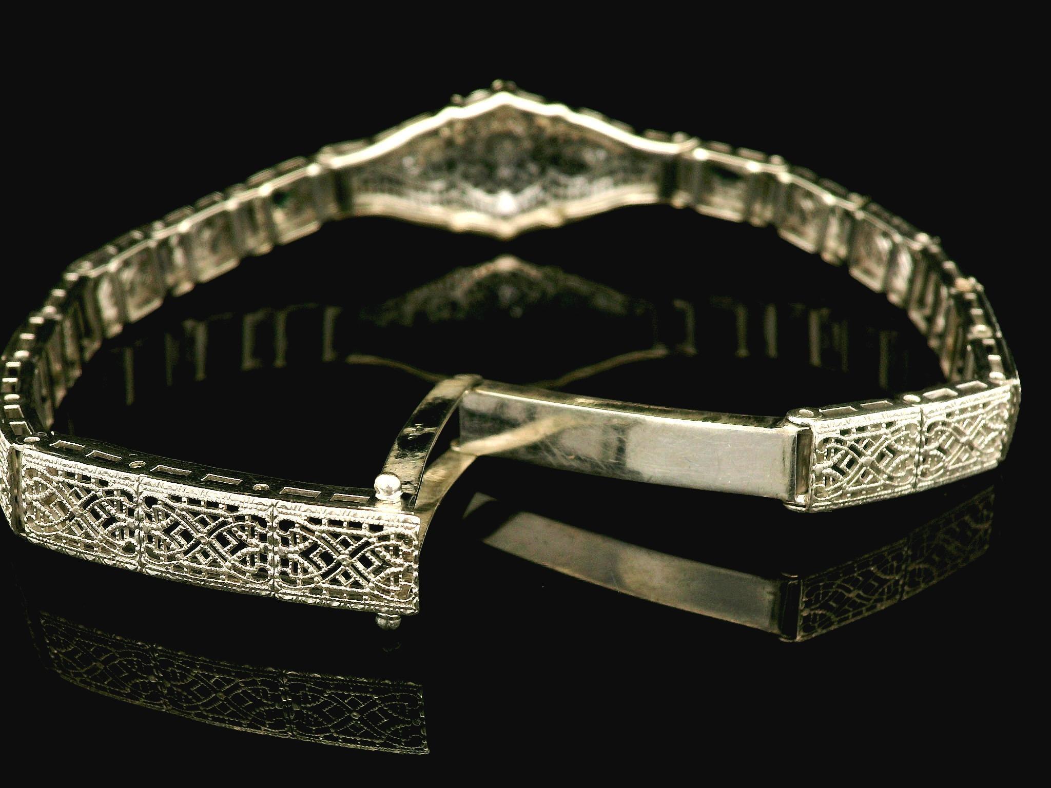 –Stone(s)–
(3) Natural Genuine Diamonds - Old Cut - Pave Set - White Color - 0.06ctw (approx.)
(2) Synthetic Emeralds - Lozenge Cut - Bezel Set - Green Color 

Material: 14k White Gold
Weight: 12.23 Grams
Type: Filigree open work Line Link
Length: