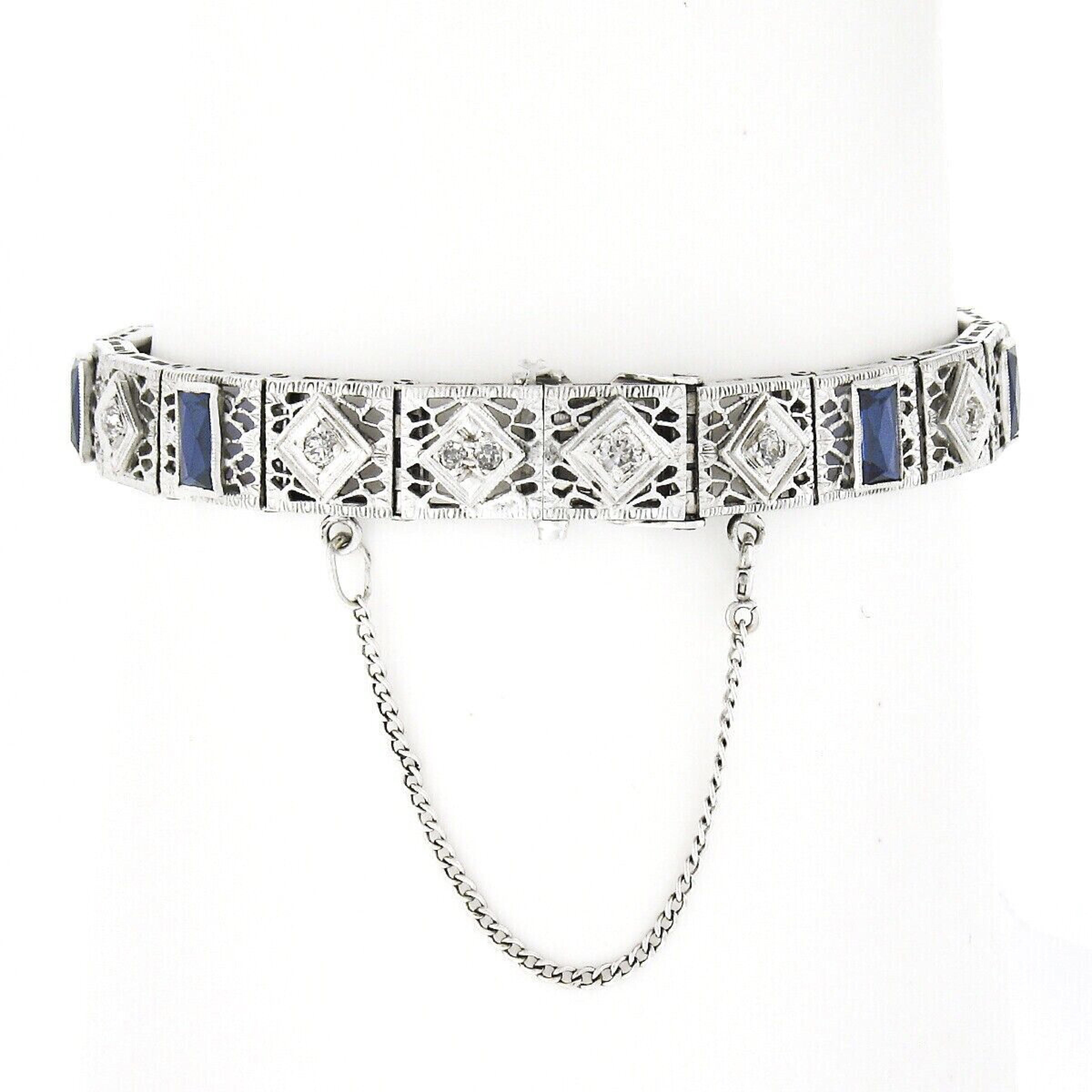 Here we have a truly breathtaking antique bracelet that was crafted from solid 14k white gold during the art deco period, featuring a domed centerpiece with magnificently executed open filigree work at each of the square links adorned with delicate