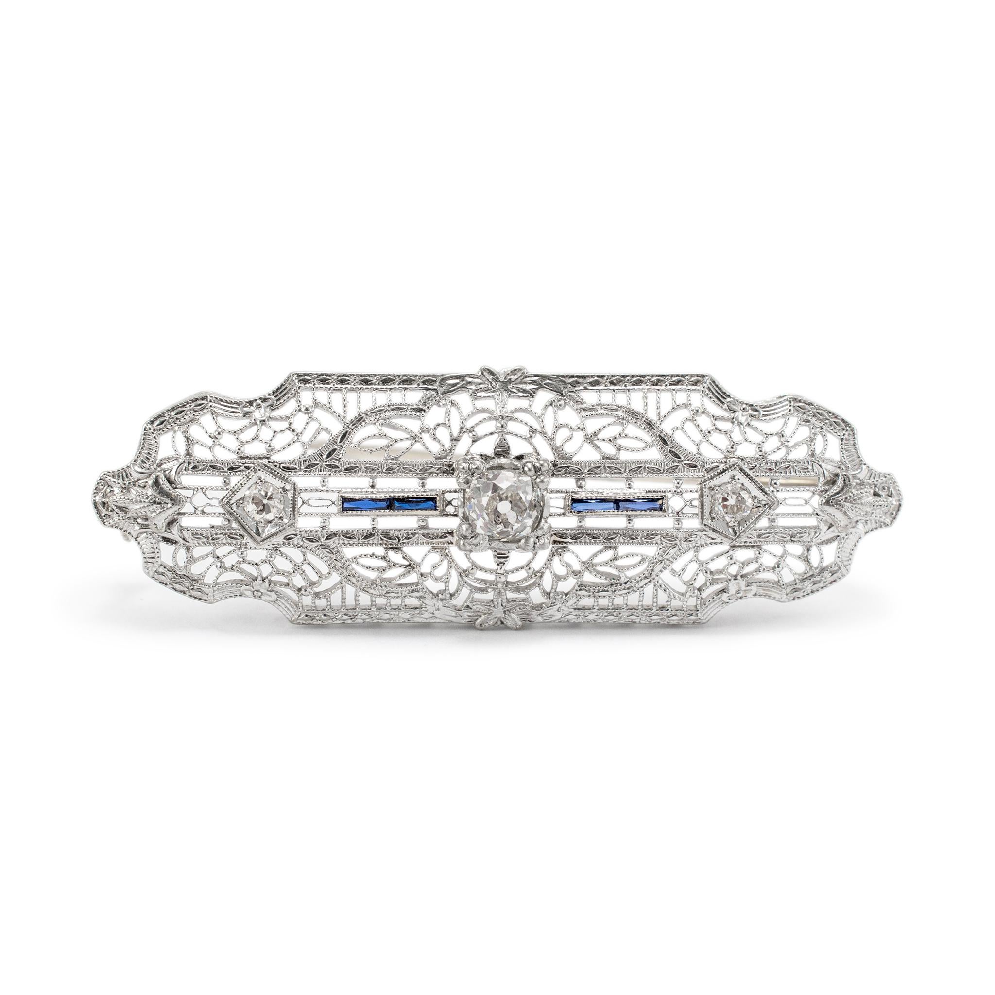 Gender: Unisex

Metal Type: 14K White Gold

Length: 2.00 inches

Width: 16.70 mm

Weight: 5.26 grams

One 14K White Gold Diamond and Sapphire art deco (1920-1930) brooch. The metal was tested and determined to be 14K white gold. Engraved with 