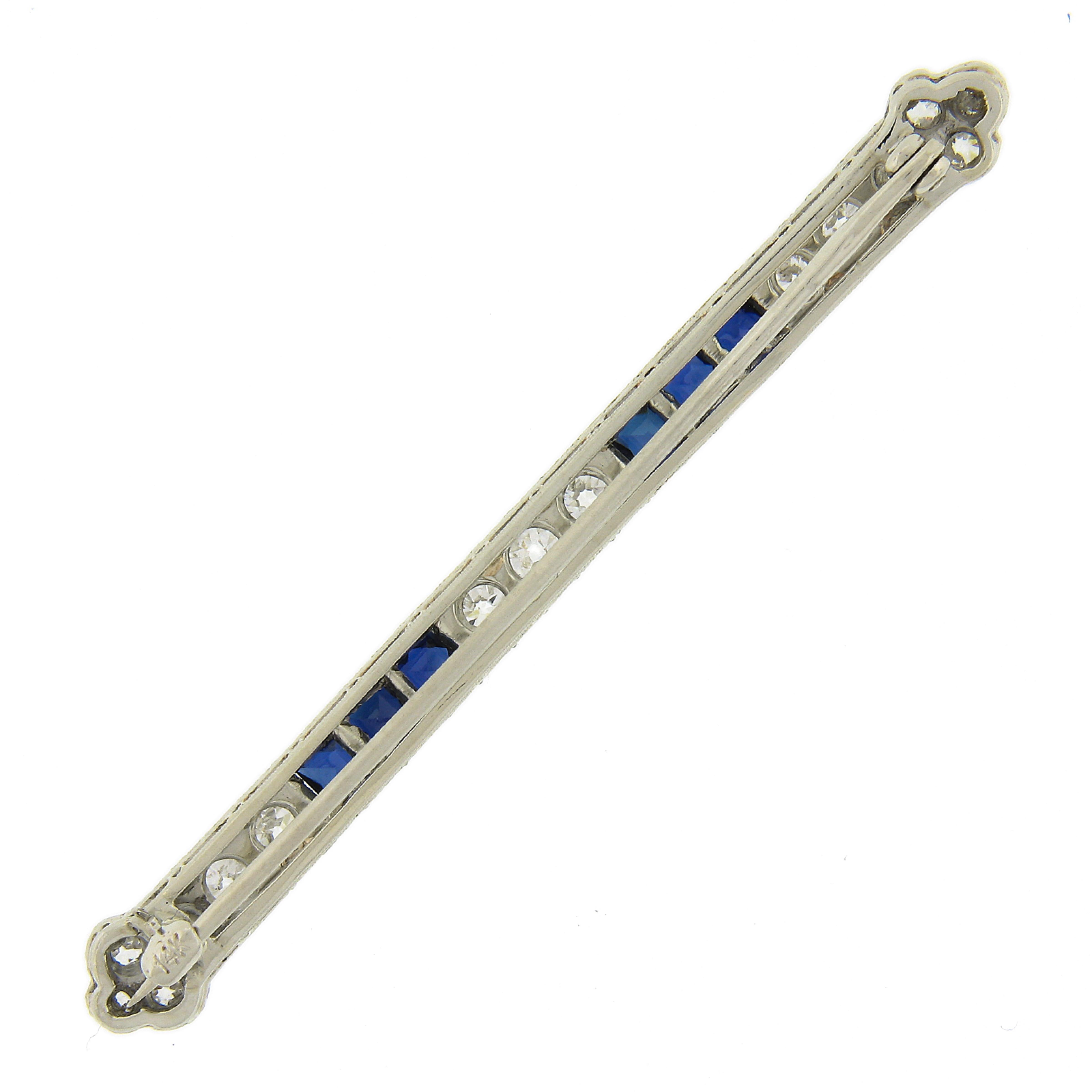 This magnificent, all original, antique bar pin brooch was crafted from solid 14k white gold during the Art Deco period and features 15 natural diamonds and 6 lab-grown sapphires of which two were randomly selected for certification by GIA. The