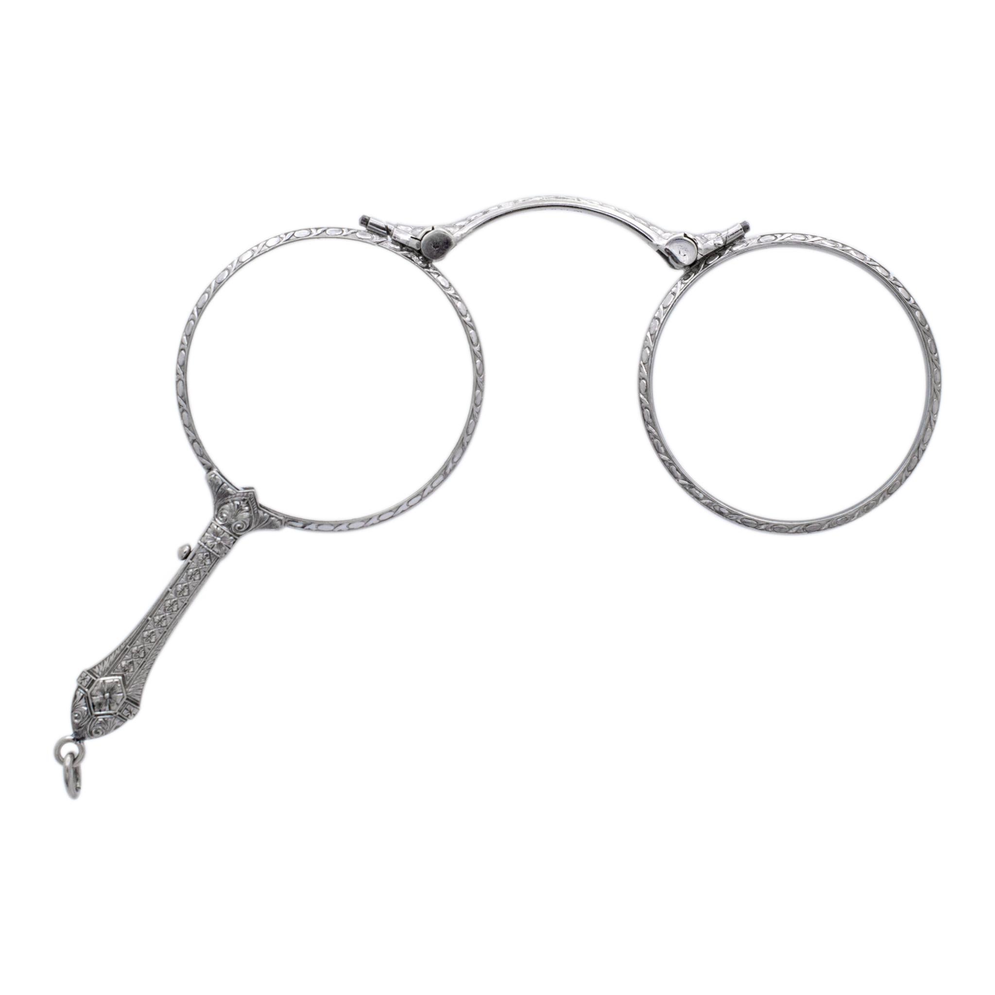 Metal Type: 14K White Gold

Length: 3.00 inches

Width: 4.00 inches

Weight: 22.16 grams

14K white gold art-deco (1920-1930) folding lorgnette folding eye glasses. The metal was tested and determined to be 14K white gold. Engraved with 
