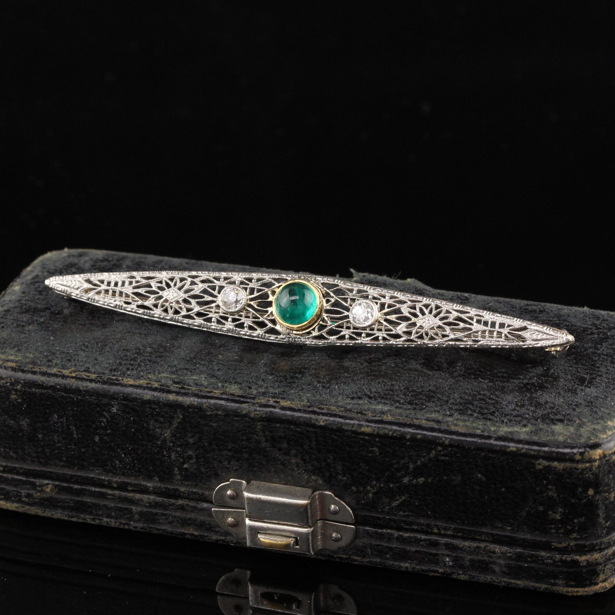 Beautiful Antique Art Deco 14K White Gold Old Euro Diamond Emerald Filigree Pin. This amazing pin is crafted in 14k white gold. The center holds a natural cabochon emerald that is a vibrant green color and has two white old european cut diamonds on