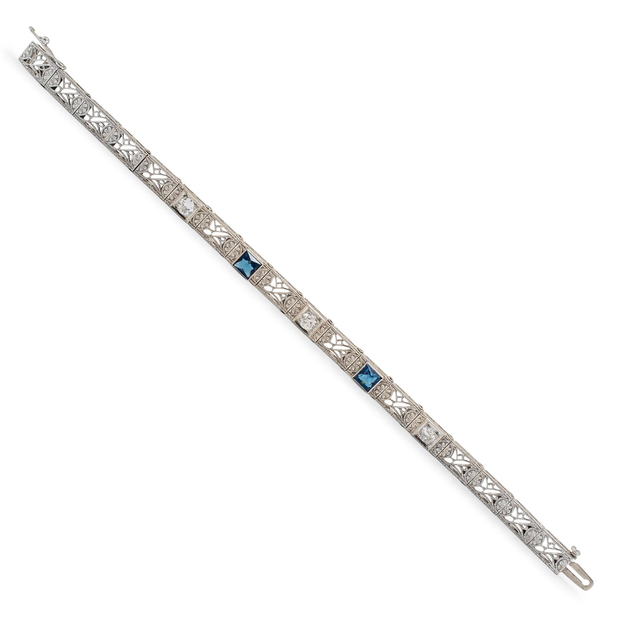 Gender: Ladies

Metal Type: 14K White Gold

Length: 5.50 inches

Width: 5.00 mm

Weight: 6.99 grams

One ladies custom made filigreed 14K white gold, sapphire and diamond link bracelet. The metal was tested and determined to be 14K white gold.