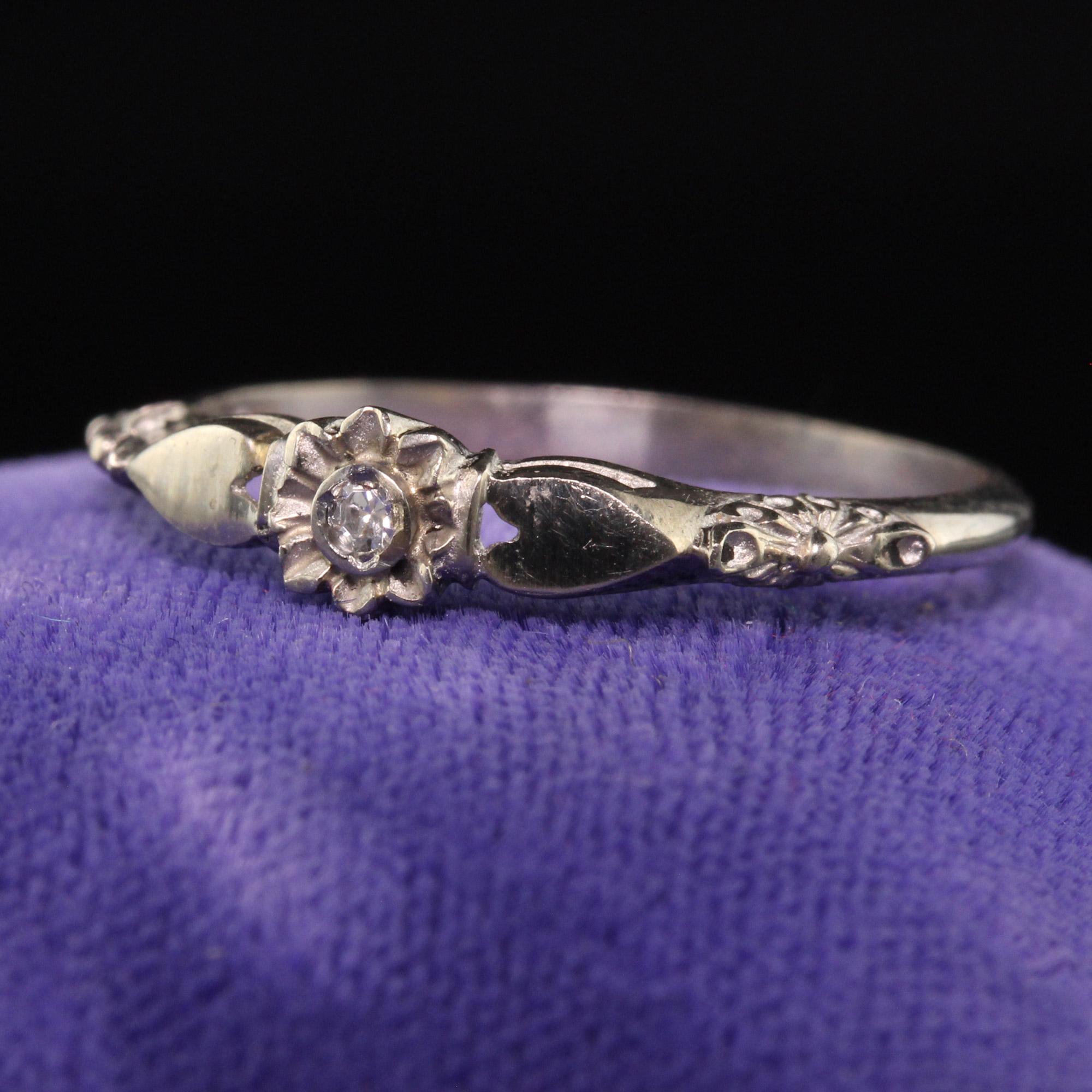 Beautiful Antique Art Deco 14K White Gold Single Cut Diamond Heart Wedding Band. This gorgeous wedding band is crafted in 14K white gold and has a single cut diamond in the center of the flower and heart shaped designs on the sides.

Item