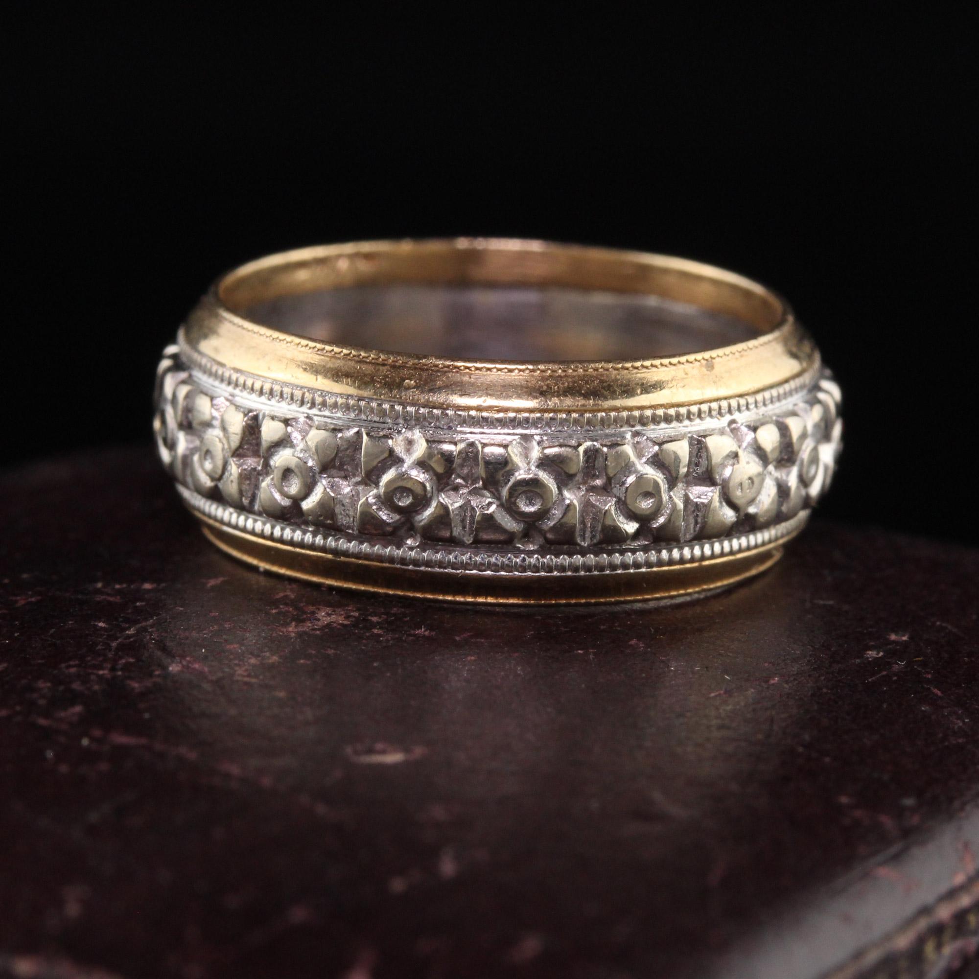 Beautiful Antique Art Deco 14K Yellow and White Gold Engraved Blossom Wedding Band. This gorgeous wedding band has the classic blossom engravings going around the entire ring in white gold and the outer edges are in14k yellow gold. It is in great