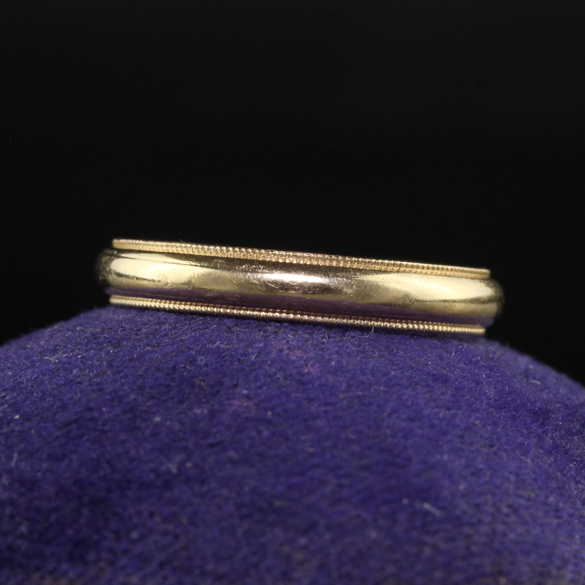 Beautiful Antique Art Deco 14K Yellow Gold Classic Milgrained Wedding Band - Size 6 1/4. This classic Art Deco wedding band is crafted with 14K yellow gold. The ring features a classic design with hand milgraining around the borders of the ring. The