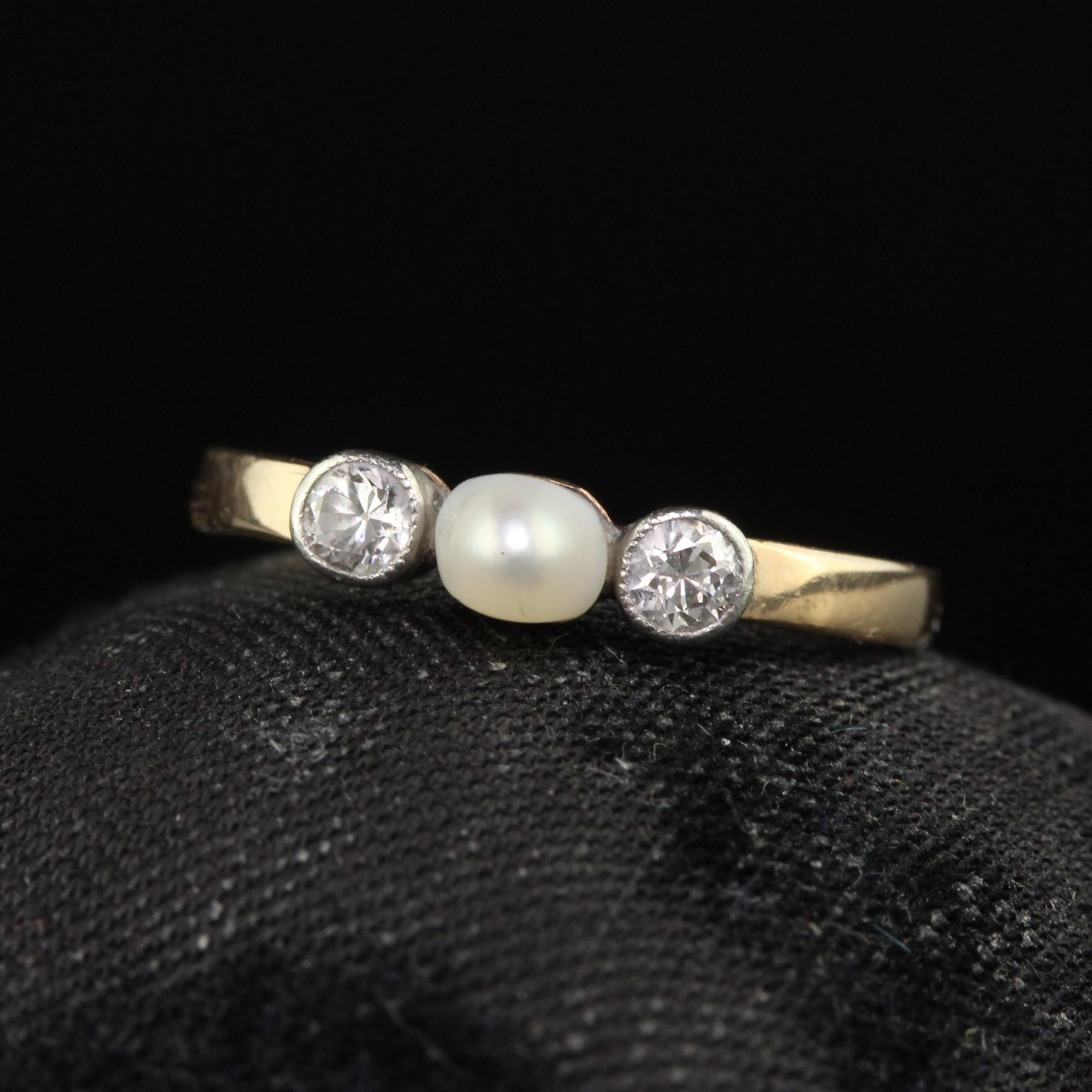 Beautiful Antique Art Deco 14K Yellow Gold Old Euro Diamond and Pearl Three Stone Ring. This beautiful ring is crafted in 14k yellow gold. There is a natural pearl in the center that has two beautiful old cut diamonds on either side. The ring is in