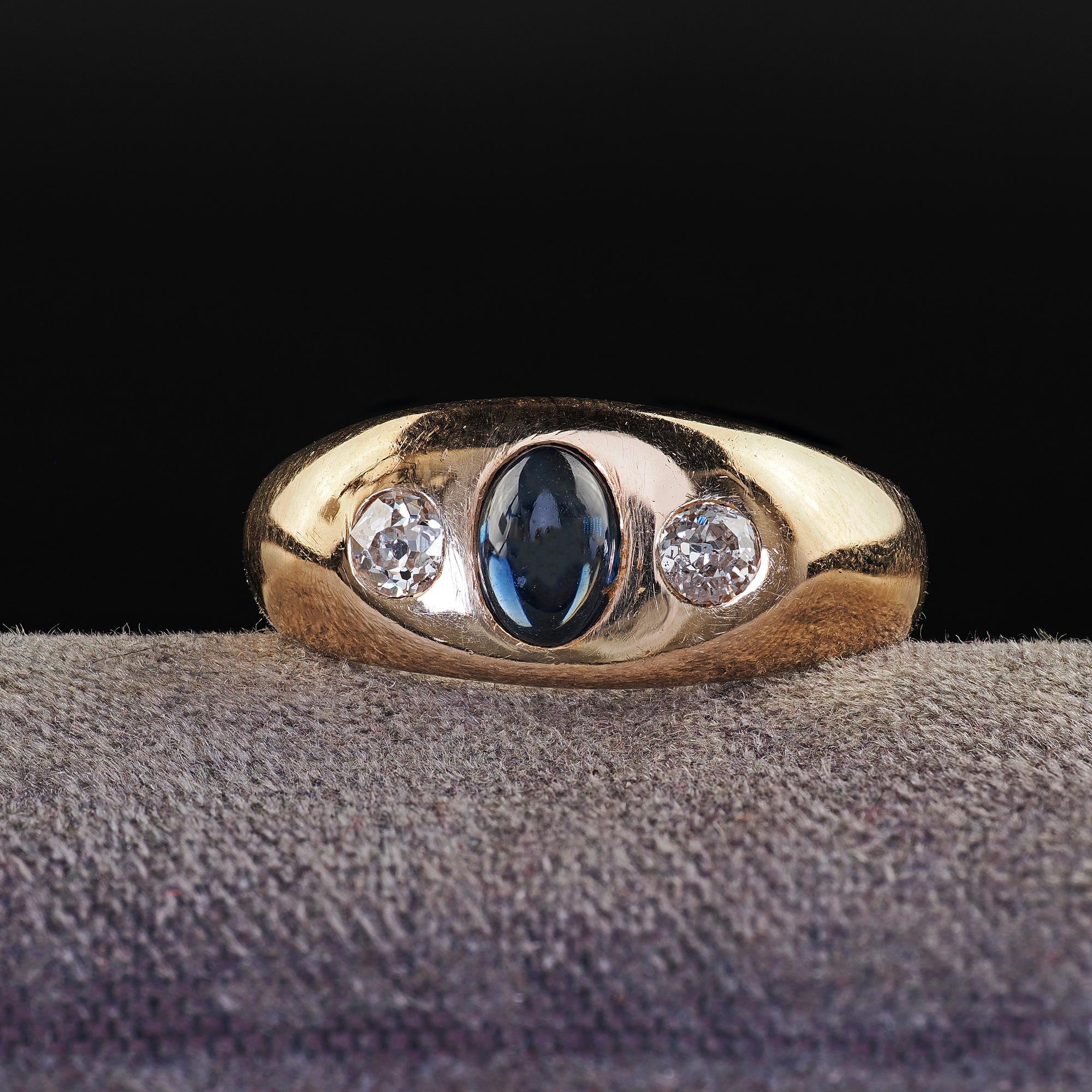 Beautiful Antique Art Deco 14K Yellow Gold Sapphire and Diamond Three Stone Ring. This classic Art Deco three stone ring is crafted in 14k yellow gold. The ring features a beautiful cabochon sapphire in the center with an old mine cut diamond on