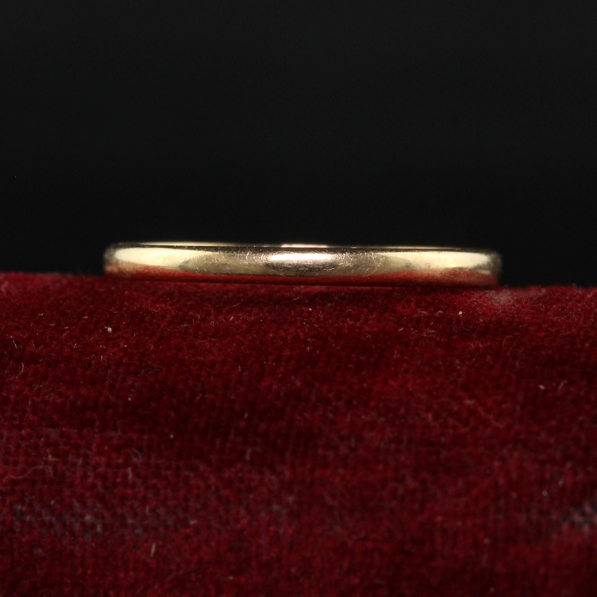 Beautiful Antique Art Deco 14K Yellow Gold Thin Classic Engraved Wedding Band - Size 7. This classic wedding band is crafted in 14k yellow gold. The ring features a classic polished design going around the entire ring and has 