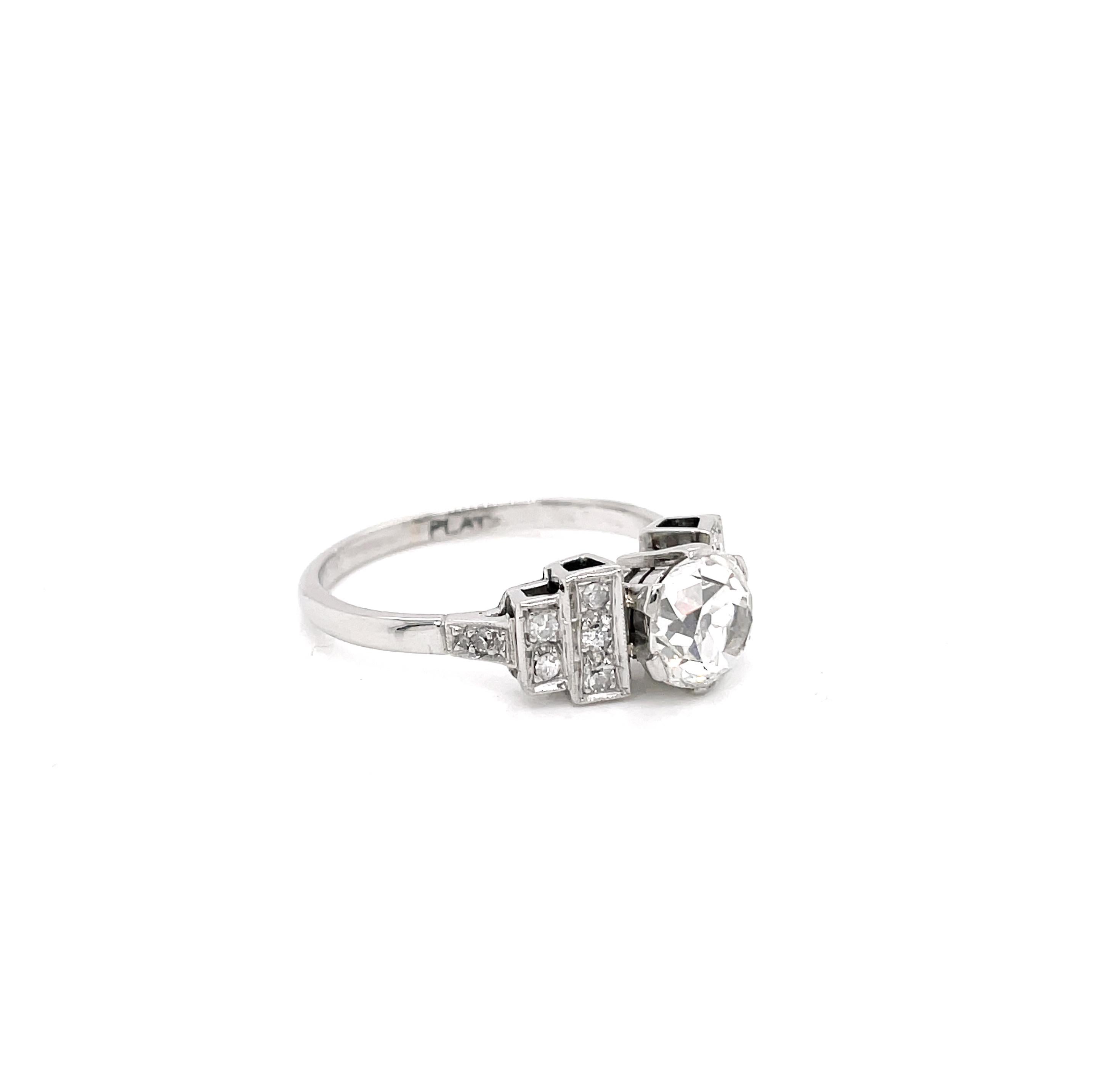 This incredible engagement ring is beautifully set with an old mine cut diamond weighing 1.75 carats mounted in a six claw open back setting. The centre stone is wonderfully designed with step shoulders, typical of the Deco period. Each shoulder is
