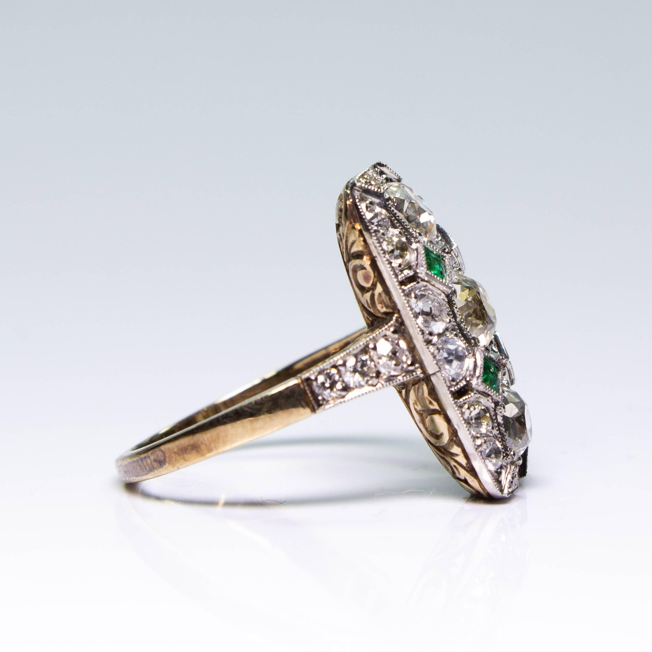 Period: Art Deco (1920-1935)
Composition: 18K gold and platinum
Stones:
•	3 Old mine cut diamonds of J/K-VS2/SI1 quality that weigh 1.45ctw. 
•	24 Old mine cut diamonds of I/J-VS2 quality that weigh 0.82ctw.
•	4 natural calibrated cut emeralds that