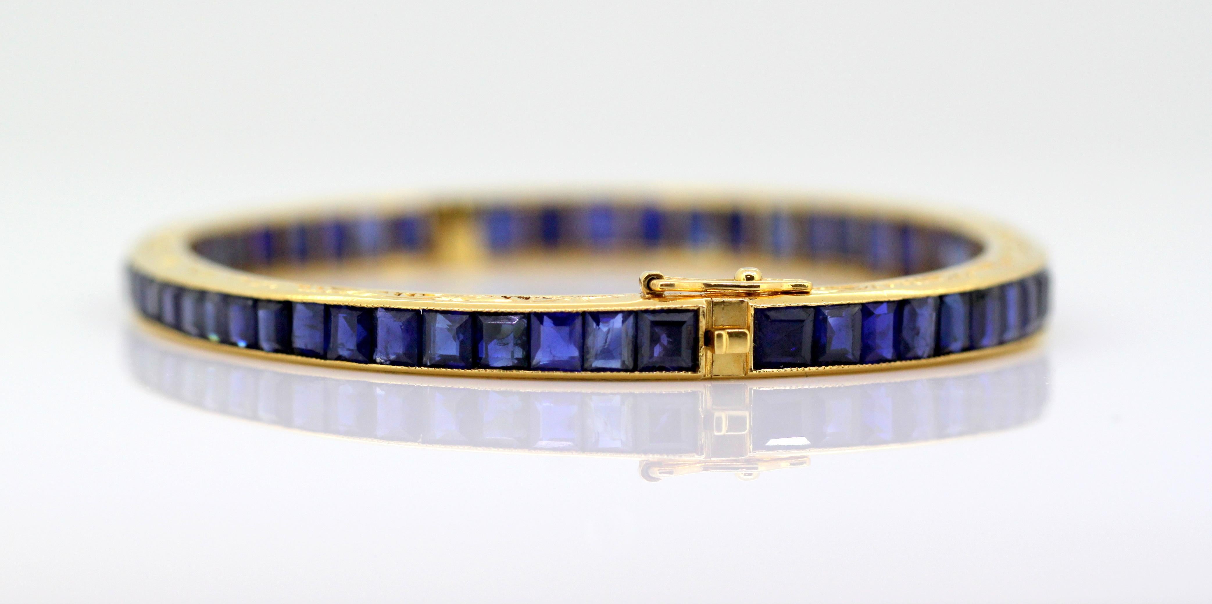 Antique Art Deco 18k gold ladies bangle with Burmese natural corundum sapphire.
Made in France Circa 1920's

Dimensions -
Size : 6.3 x 5.5 x 0.55 cm
Weight : 17 grams

Sapphires -
Total Weight : 16.5 CT Approx
Shape : Calibrated cut
Colour :
