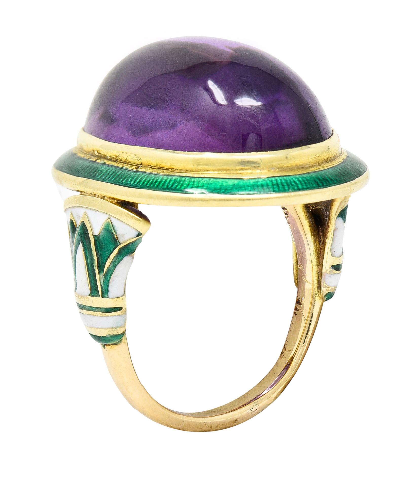 Featuring a mixed buff top amethyst cabochon measuring approximately 19.0 x 13.0 mm. Transparent with uniform pinkish purple color - medium saturation. Bezel set in gold and surrounded by a bright green guilloche enamel halo.
Shoulders are stylized