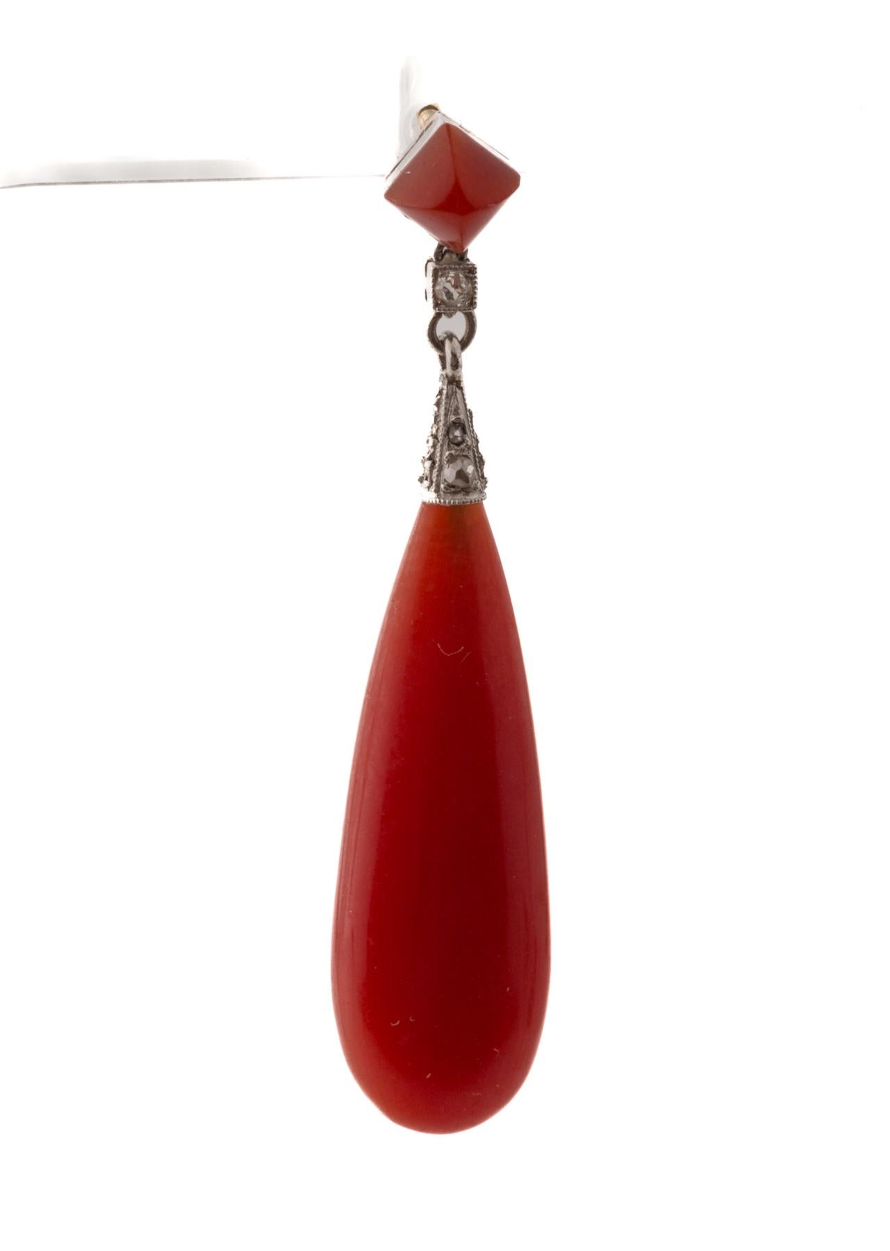 Light in weight and lush natural coral color these Art Deco earrings are a joyful addition to every wardrobe. Dating from c.1920 they have timeless beauty. Smooth coral in a teardrop have the sparkle of small diamonds at the top. From your office to