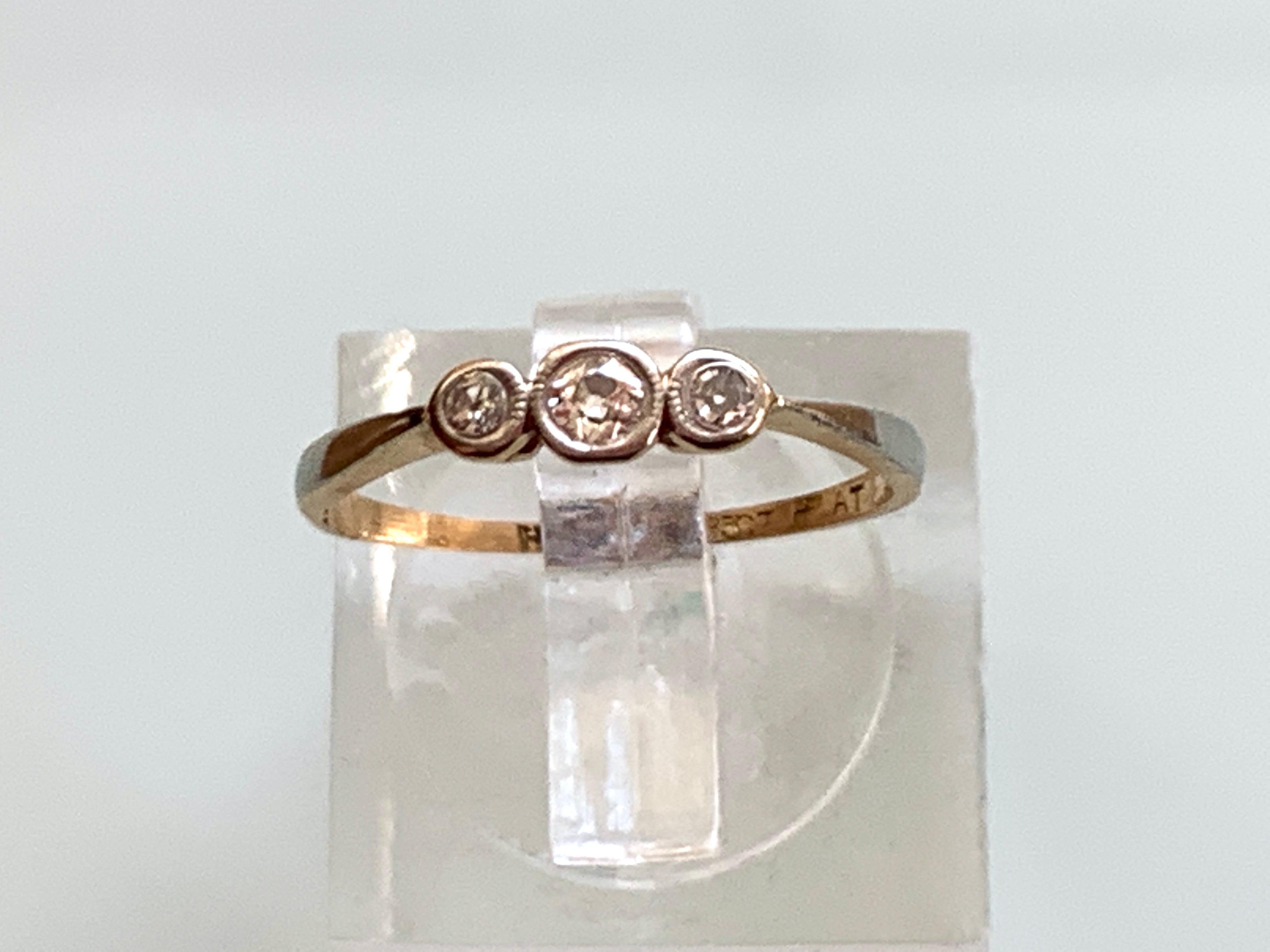 Vintage 18ct 750  Gold 0.10 Carat Diamond Ring 
3x Genuine natural diamonds 1.5mm , 2.5mm, 1.5mm
set within  platinum framed in an 18ct Gold Ring 
Makers H.G & S
Size   U.K  I (i)
          U.S  4 1/2
inside band diameter 15.04 mm
Era 1920s 
Weight