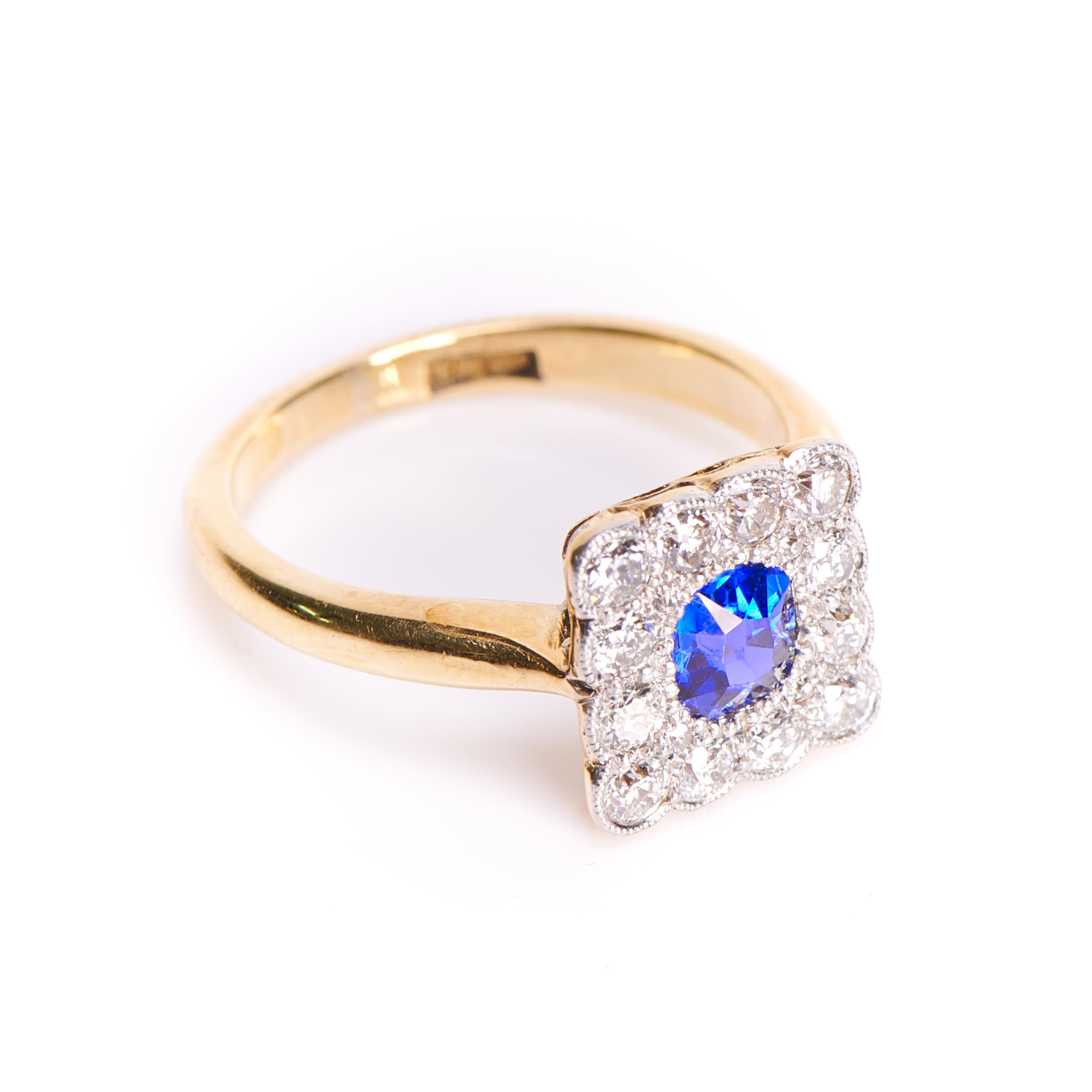 The square setting of this ring is set with old European-cut diamonds surrounding a beautifully proportioned cushion-shaped sapphire in a cornflower blue hue. The borders are dotted using the 'millegrain' technique, which jewellers developed at the