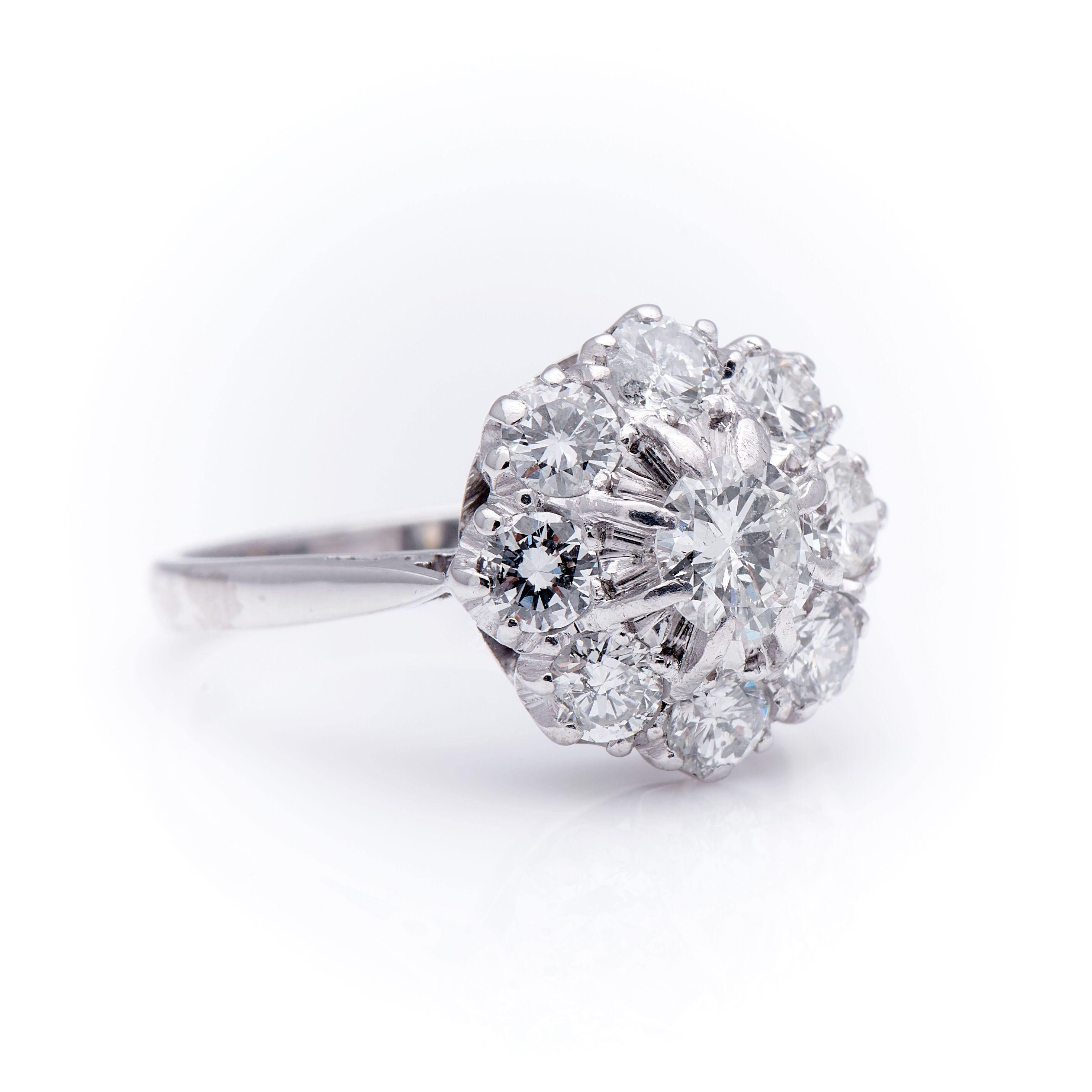 Art Deco, diamond cluster ring, circa 1920. An absolutely stunning ring set with nine beautifully white diamonds (comfortably over 1ct total) of excellent clarity. Set to centre a larger old transitional-cut diamond with a boarder of smaller