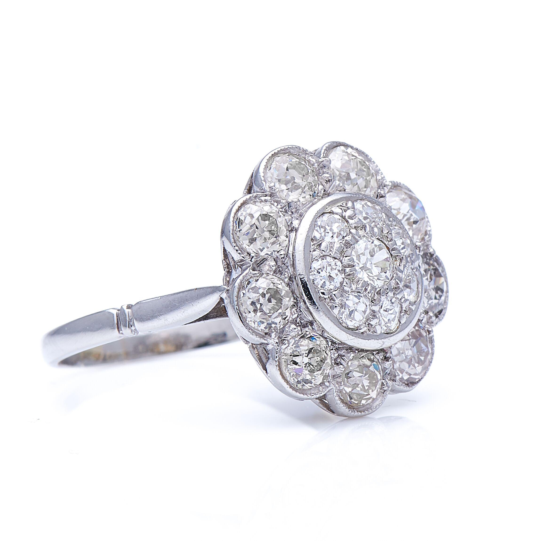 Diamond ring, vintage. A bold, exuberant take on the traditional floral cluster, the bombé centre of this ring is pavé-set with circular-cut diamonds, an glamorous and effective alternative to the usual single central stone. 

MARK
None

METAL
18