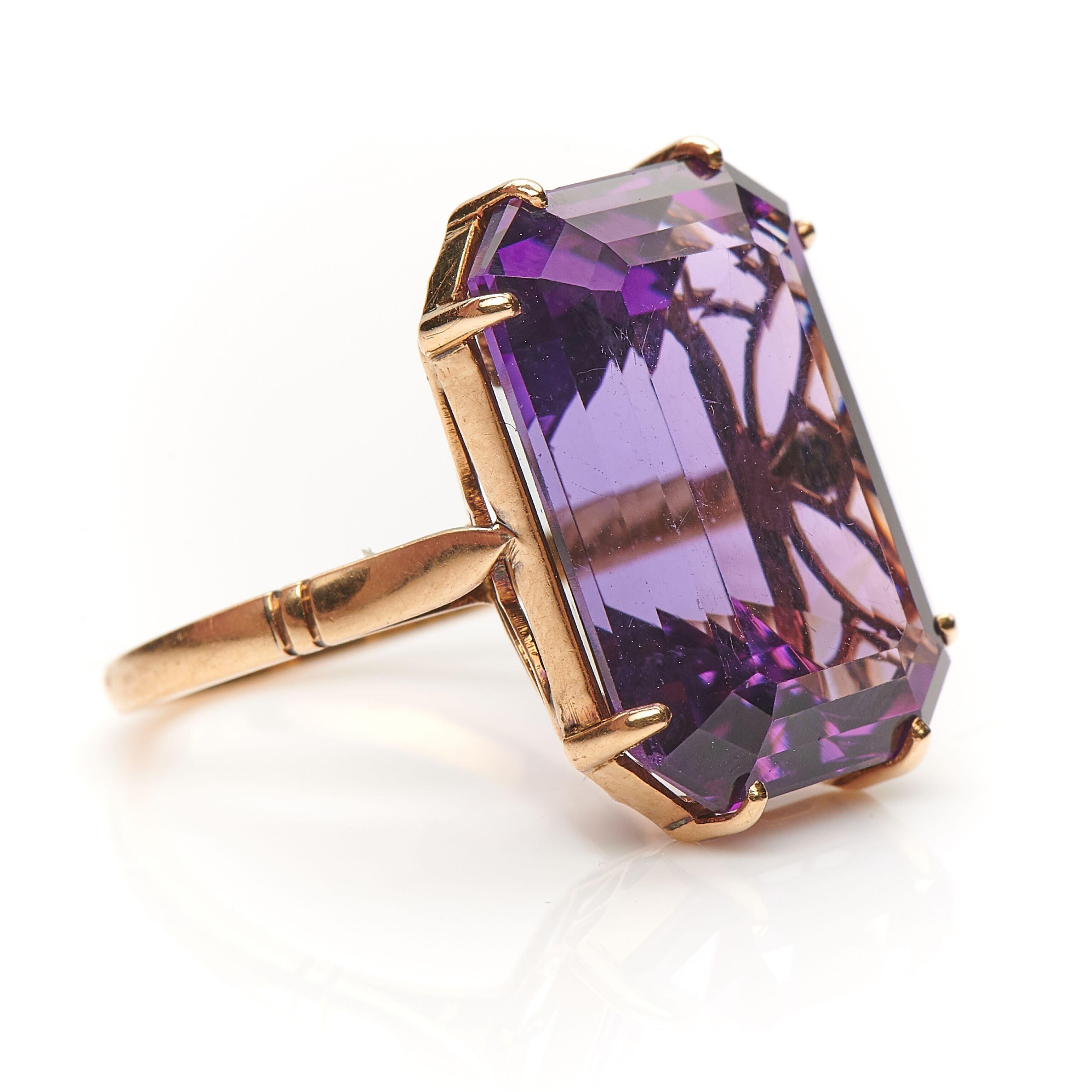 Art Deco, solitaire amethyst ring, circa 1920. Set with an emerald-cut single amethyst in a deep shade of violet purple in a beautifully made open-back setting in 18ct yellow gold. This ring is elegant and simple, making it very easy to wear and