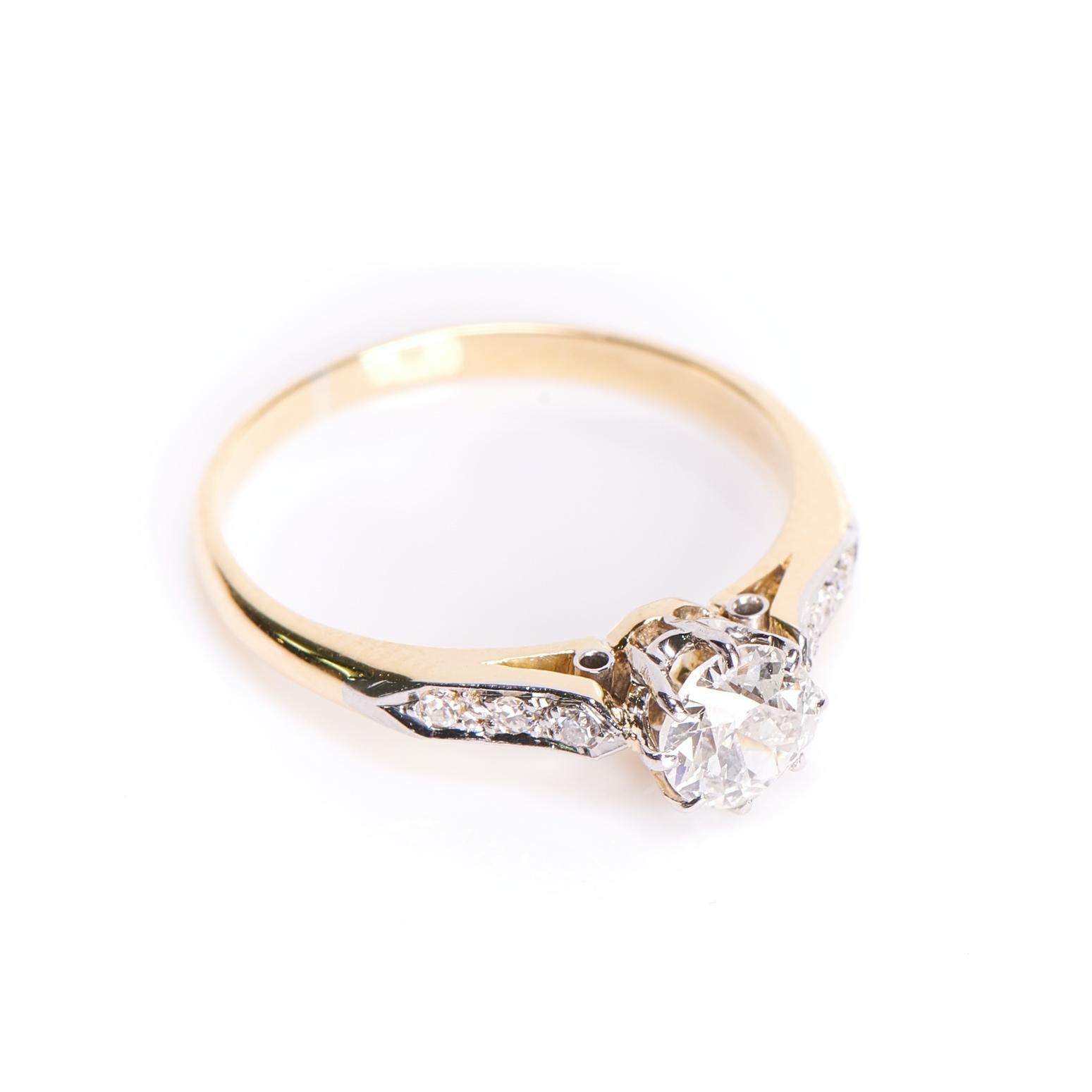 Art Deco diamond ring, circa 1920. A beautiful traditional diamond engagement ring set with a 0.50ct transitional-cut diamond in an eight-claw setting flanked by shaped diamond shoulders all set in platinum. The band is made in yellow gold adding a