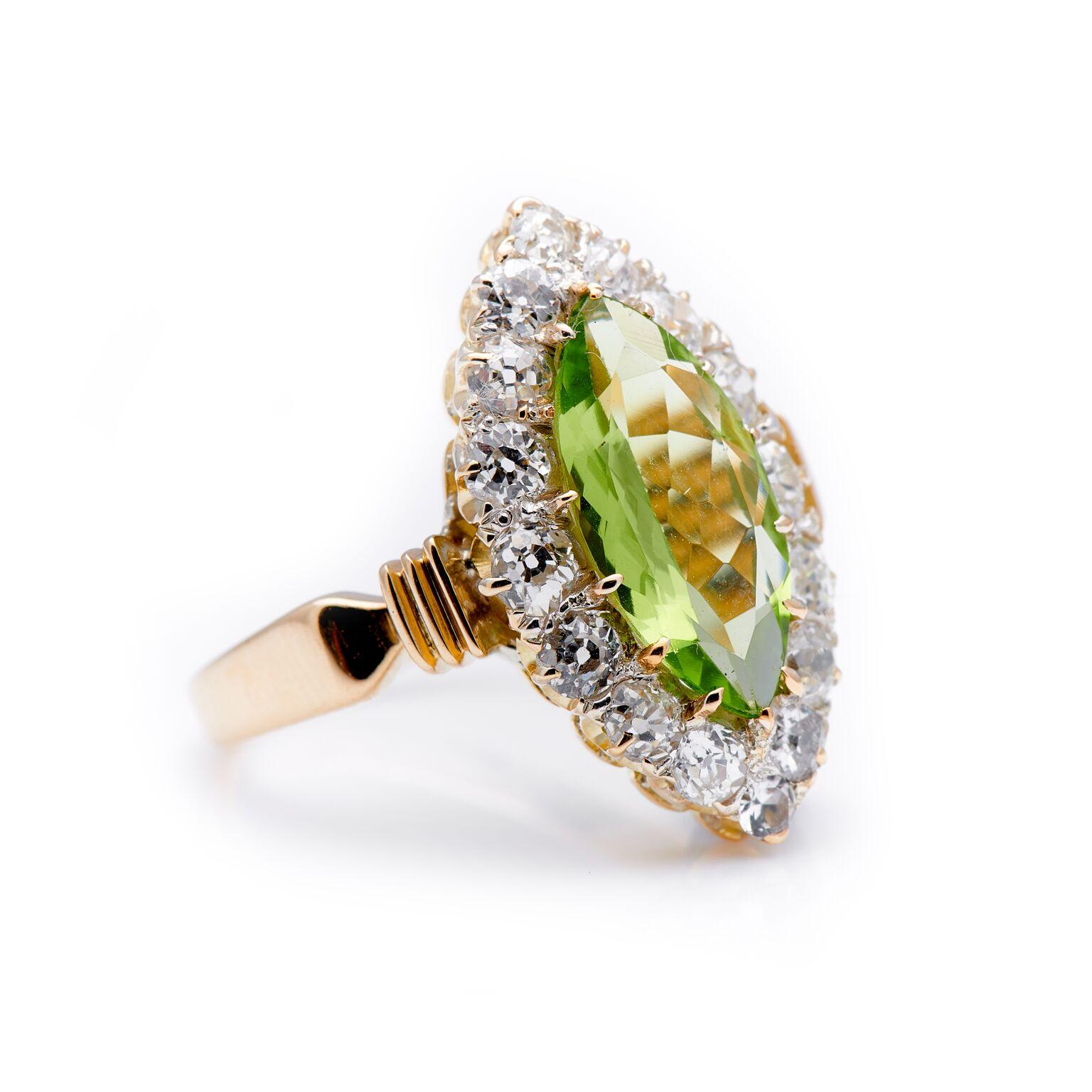 Art Deco, peridot and diamond cluster ring, circa 1925. Set to centre a wonderful bright green peridot surrounded by a single row of old-cut diamonds. What makes this ring particularly special is the marquise-cut peridot, and the overall shape of