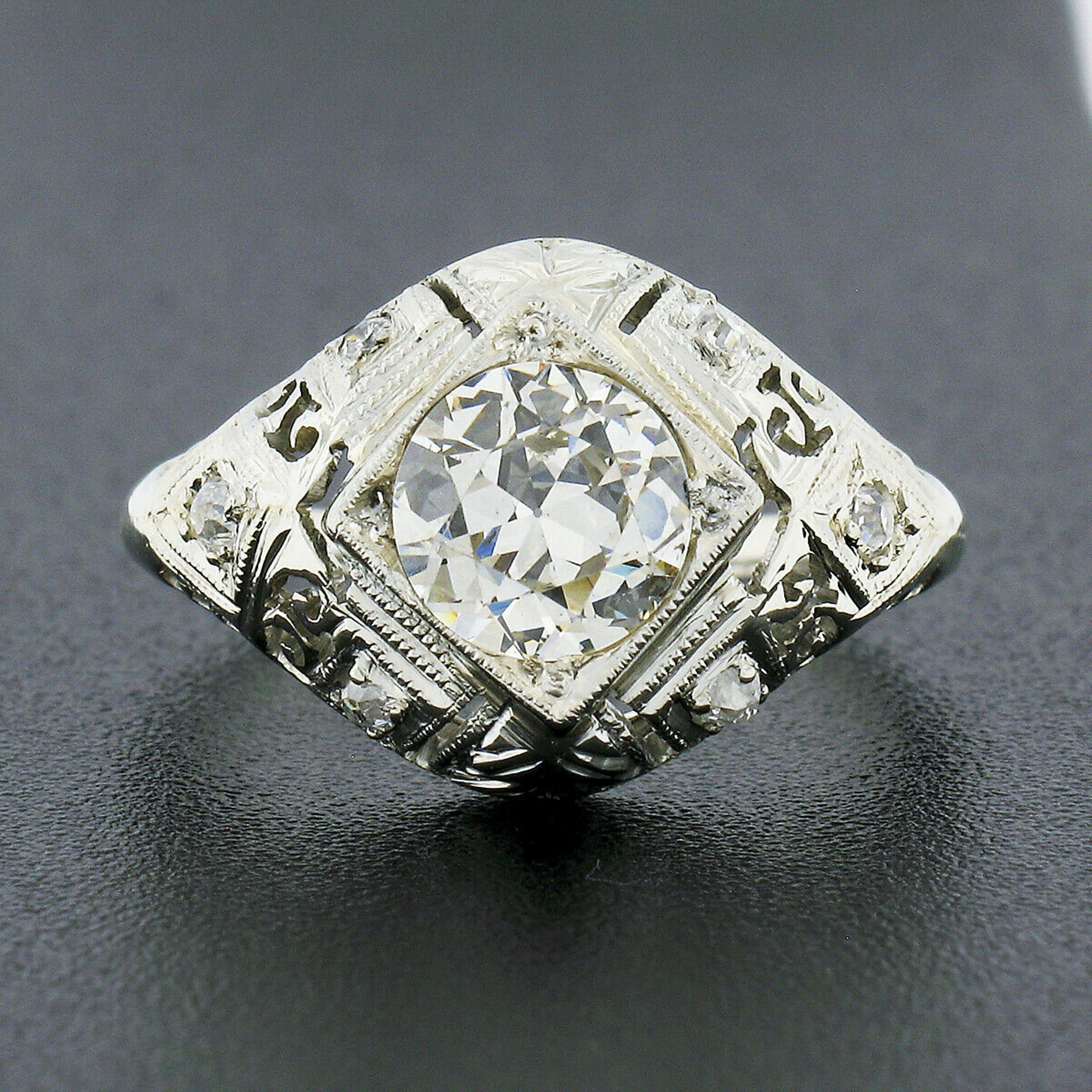 You are looking at a truly magnificent and gorgeous art deco period engagement ring that is crafted in solid 18k white gold featuring a stunning circular brilliant (old European) cut diamond solitaire neatly bead set at its center. The lively