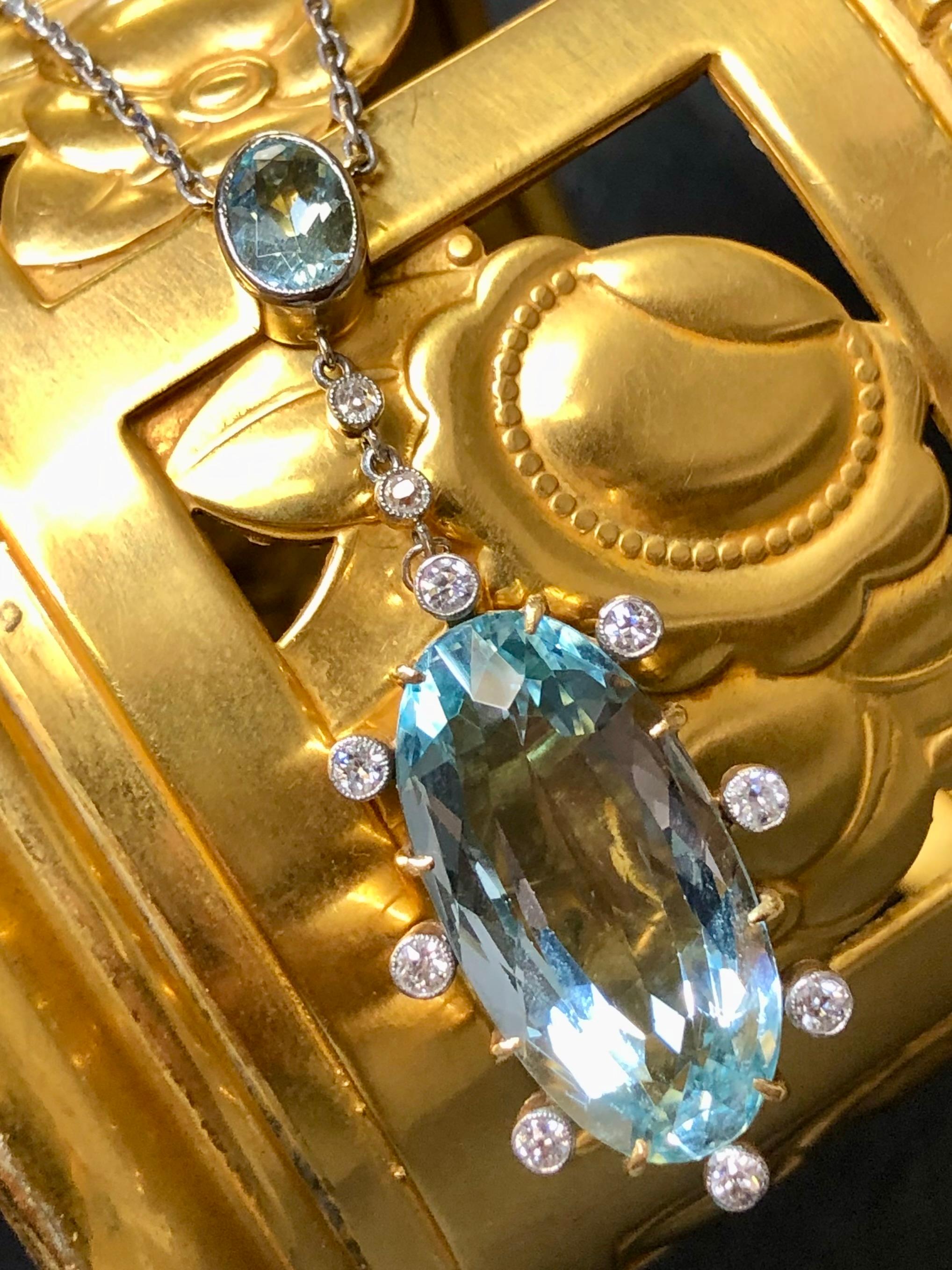 An exceptional piece of antiquity that is not only rimless and elegant, but also extremely wearable. This original Art Deco necklace is done in platinum and 18K yellow gold boasting an approximately 20ct natural aquamarine studded in bezel set H-I