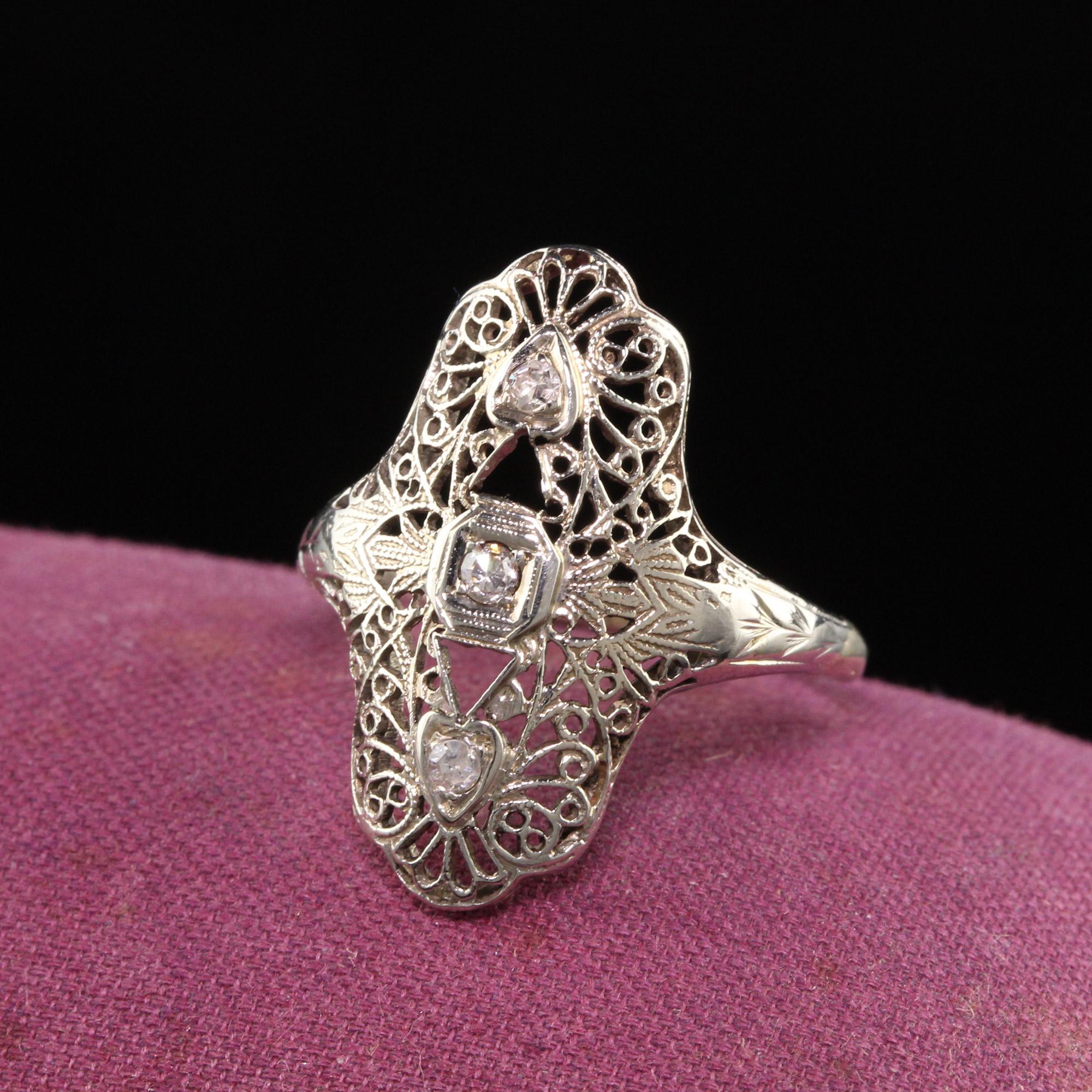 Beautiful Antique Art Deco 18K White Gold Diamond and Filigree Shield Ring. This gorgeous filigree ring has 3 single cut diamonds on it with fine filigree work all over it.

Item #R0980

Metal: 18K White Gold

Weight: 3.4 Grams

Diamonds: