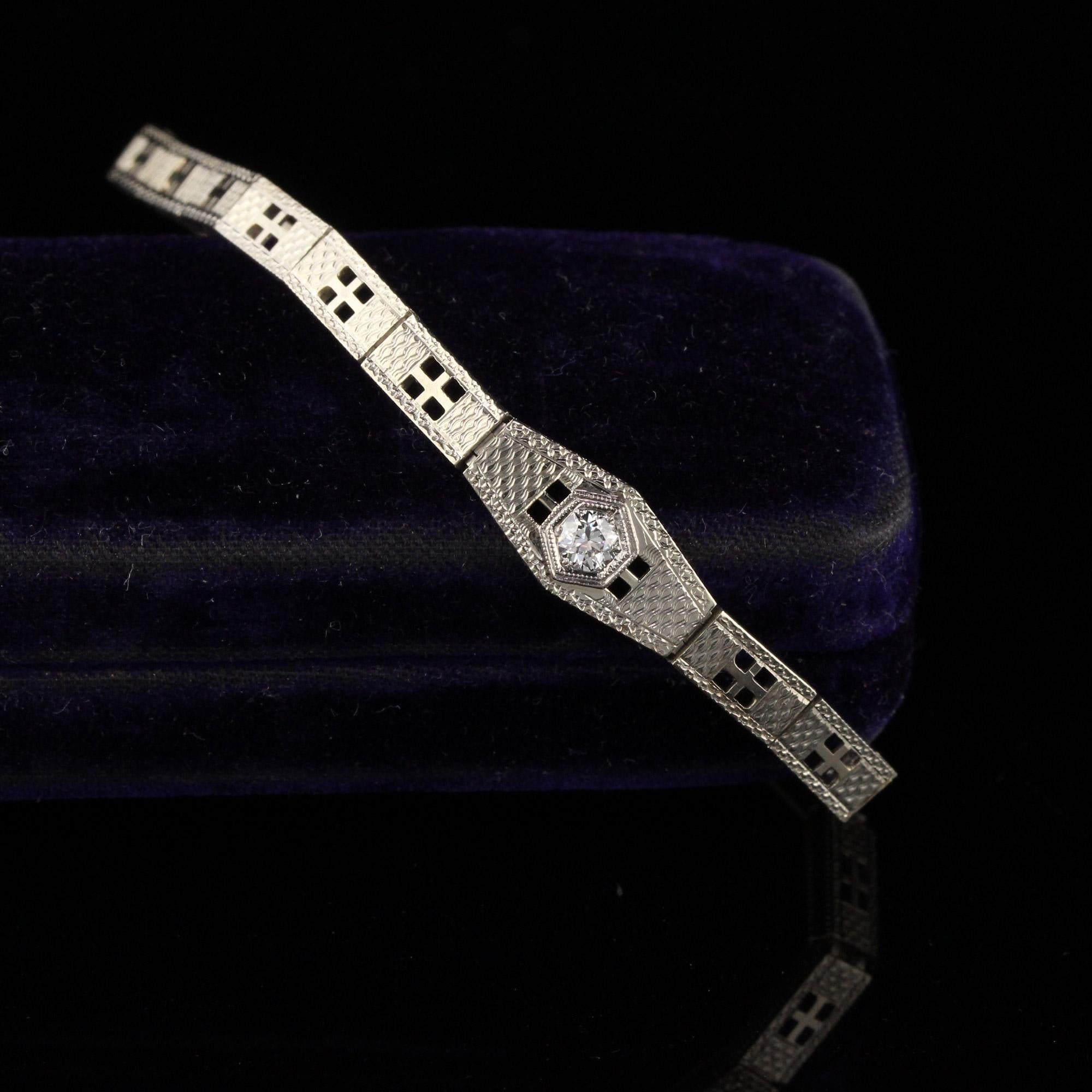 Gorgeous antique 18K white gold bracelet with a round diamond center. 

Item #B0027

Metal: 18K White Gold

Weight: 11.9 Grams

Total Diamond Weight: Approximately 0.15 cts 

Diamond Color: H

Diamond Clarity: VS1 

Bracelet Length: 6.75