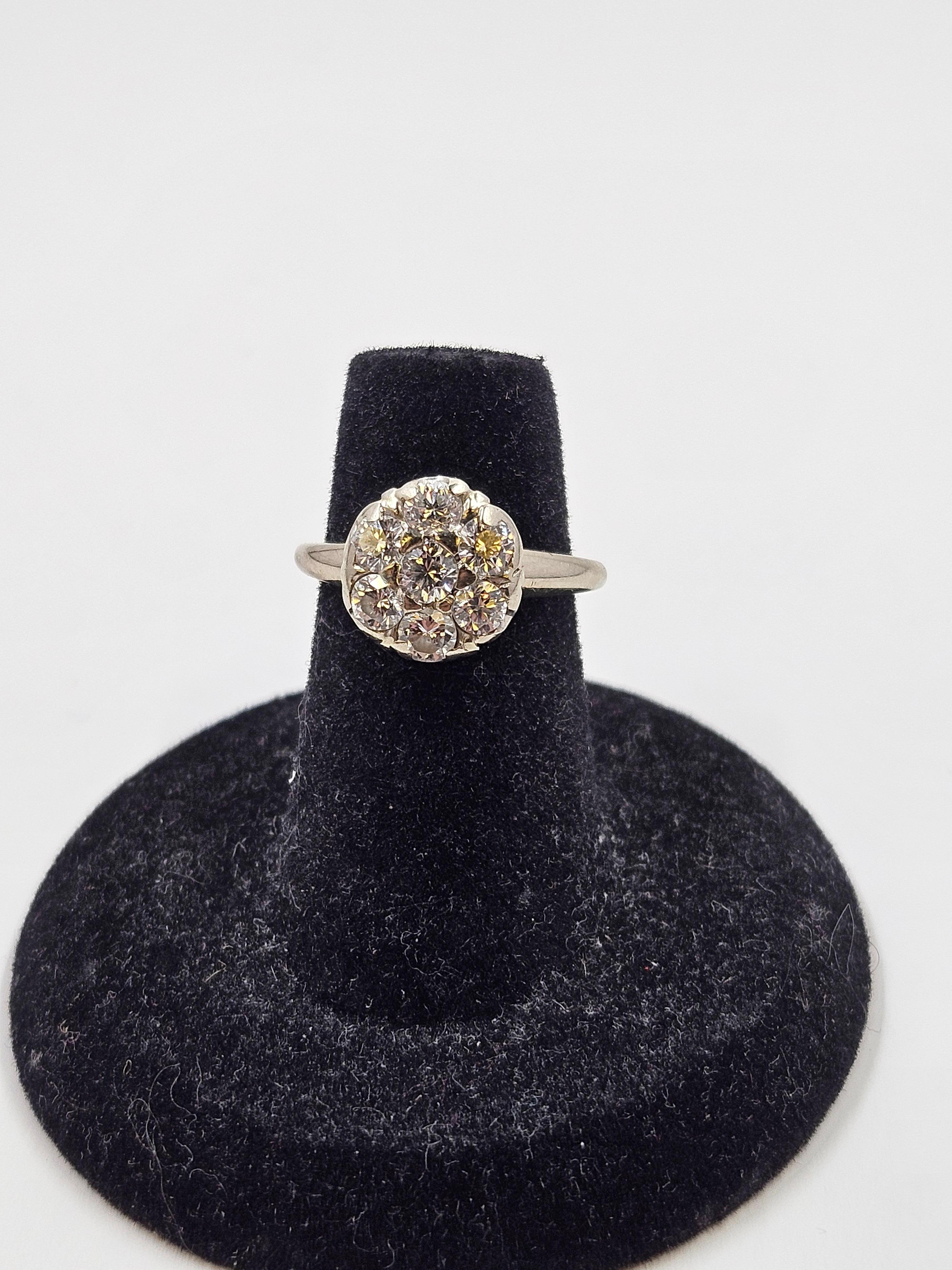 Antique art deco 18K white gold diamond cluster ring. Size 4.75. The cluster consists of 7 3.5mm diamonds with a total head size of 11mm. The ring weighs 3.1 grams. There is minimal finish loss. Wear is consistent with age and use. The diamonds
